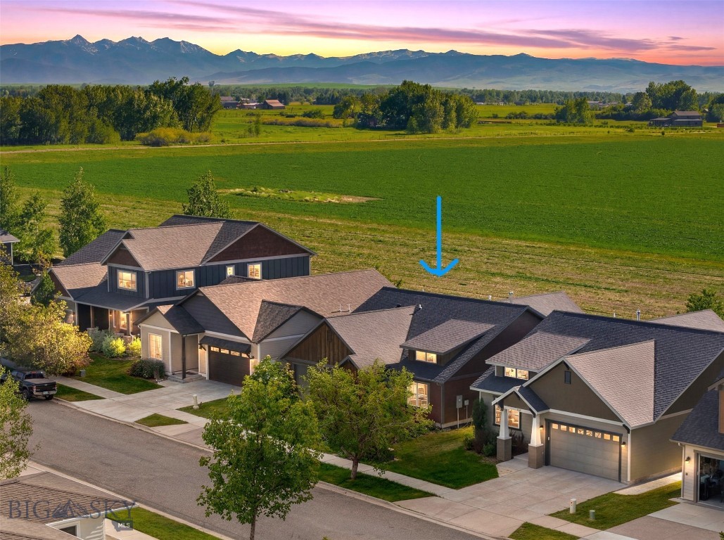 Enjoy the perfect blend of convenience, comfort, and Montana scenery in this beautifully maintained single-level home located in the sought-after Loyal Gardens neighborhood on Bozeman's desirable west side. Backing directly to open farmland and the City of Bozeman boundary, this property offers exceptional privacy, unobstructed views, and spectacular sunsets over the Tobacco Root and Spanish Peaks mountain ranges. The thoughtfully designed floor plan features three bedrooms, two bathrooms, and an inviting open-concept living area highlighted by rich wood flooring, a cozy gas fireplace, built-in shelving and storage cubbies, and abundant natural light. The kitchen and dining areas flow seamlessly into the living space, creating an ideal setting for both everyday living and entertaining. Vaulted ceilings in two of the bedrooms enhance the home's spacious feel, while tile bathroom floors and quality finishes add style and functionality throughout. Step outside to enjoy Montana's outdoor lifestyle from the large covered patio complete with roll-down sun shades. The fully fenced backyard features a raised garden bed, a mature Mount Royal plum tree, and a matching 8' x 10' storage shed, providing plenty of space for gardening, relaxing, and recreation. Additional amenities include built-in speakers, ceiling fans, traditional wood shutters, an alarm system, underground sprinklers, an attached two-car garage, and well-maintained landscaping. Ideally situated near restaurants, fitness centers, healthcare facilities, Montana State University, and outdoor destinations including Hyalite Canyon, this home offers the rare opportunity to enjoy peaceful open-space views while remaining just minutes from everything Bozeman has to offer.