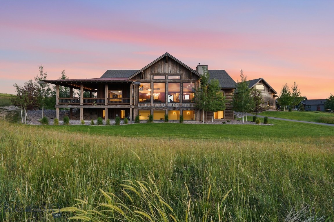 Set on 1.27 acres in Springhill Reserve, 46 Moon Shadow is a home that feels as though it was built into the view itself. While construction originally began in 2021, the home was only recently completed, offering the rare opportunity to own a residence that lives like brand new. Designed to fully capture one of Montana’s most extraordinary landscapes, the mountain views don’t simply surround the property, they become part of the experience inside the home. From nearly every room and every corner of the property, sweeping vistas stretch across the Bridger Mountains, Hyalite, the Spanish Peaks, and the Tobacco Root Range. To have this level of immersive mountain presence, while being just minutes from downtown Bozeman, is an offering rarely found.

The moment you step inside, the outdoors become part of the experience. Vaulted ceilings, beautiful beam work, white oak flooring, and walls of glass create the warmth and character of a luxury mountain retreat while filling the home with natural light. At the heart of the residence, the open-concept kitchen and great room invite gathering, anchored by a wood-burning fireplace and an oversized island designed for everything from casual mornings to holiday celebrations.

Outdoor living is equally remarkable. The northeast covered deck offers a front-row seat to sunrise over the Bridgers, while the expansive southern deck provides the perfect setting to watch summer storms roll through the valley, fireworks light the horizon, and sunsets settle across three iconic mountain ranges.

The 6,090 square-foot main residence offers six bedrooms, including a bonus room above the garage, along with multiple living spaces designed for both entertaining and everyday comfort. A detached 1,584 square-foot guest residence adds exceptional flexibility, complete with its own two-car garage, full kitchen, laundry, spacious bedroom suite, walk-in closet, and private outdoor living spaces.

This property combines the privacy and beauty of Montana living with the convenience of being just minutes from Bozeman. Enjoy the open space, trails, and natural beauty that define Springhill Reserve, all while coming home to a setting where every window frames a view worth pausing for.

46 Moon Shadow is more than a home, it’s a place to gather, unwind, and experience Montana at its finest.

Some photos are AI staged.