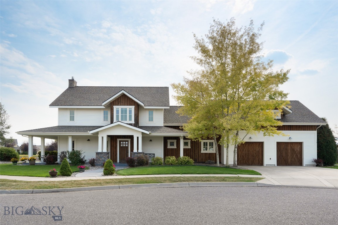 Built by Dovetail Construction and set on one of the largest in-town lots in Bozeman, this custom white farmhouse is a genuinely uncommon find. Adjacent open space buffers the property on one side, extending the sense of privacy and framing sweeping views across multiple mountain ranges — all while sitting minutes from Downtown Bozeman and Bozeman Yellowstone International Airport. The architecture is classic farmhouse — wraparound porch, clean lines, real presence on the street — but the interior reflects a more current sensibility. Over 3,600 square feet of well-considered living space across four bedrooms and three and a half baths, with a floor plan that lends itself to easy main-level living. The main-level primary suite, generous common areas, and well-proportioned rooms mean the home lives comfortably day to day without needing to navigate stairs for much of anything. An expansive upstairs family room adds flexibility for guests, hobbies, or a dedicated retreat. Built-in radiant heat provides reliable warmth through Montana winters, and the current owners have added mini-split AC units throughout, keeping the home equally comfortable through summer. The oversized heated garage is worth a closer look — two front-facing doors plus a double door on the back side make for easy drive-through access and genuine versatility, whether that's for vehicles, a workshop, or serious storage needs.
The outdoor spaces are equally considered. A large fenced yard, wraparound porch, and that rare adjacency to open space create an outdoor living experience that most in-town properties can't replicate. The backyard shed is a flexible bonus — equally suited as a gardening and storage hub, a she-shed, or a playhouse depending on who's using it. The mountain views are a constant backdrop. The location adds another layer of quiet that's worth noting. Positioned on a private cul-de-sac, with the adjacent street also dead-ending rather than cutting through, through-traffic here is essentially nonexistent. Yet schools, parks, and local amenities are close at hand, and Downtown Bozeman's restaurants, shops, and events are just minutes away, as is access to the region's year-round outdoor recreation. A custom home, a landmark lot, and a location that holds its value. Opportunities like this don't repeat themselves often in this market.