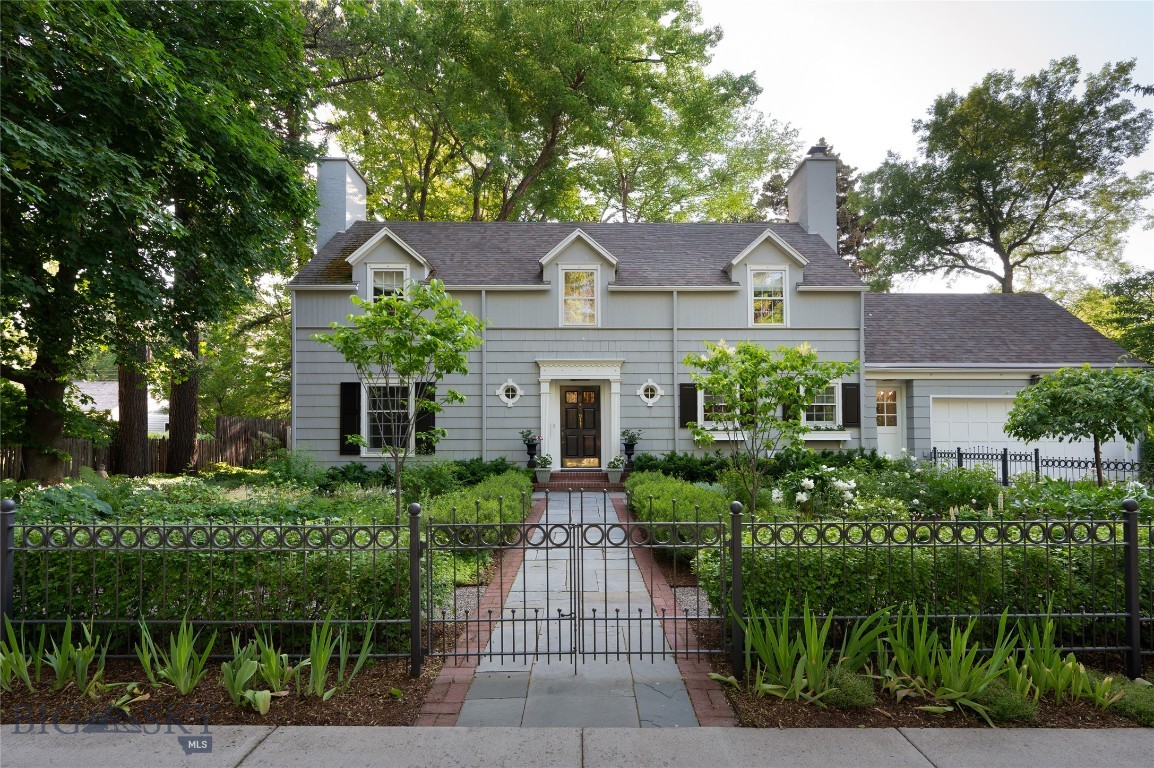 Situated on one of Bozeman's most iconic & tree-lined avenues, the Scherer House is a shining example of early 20th-century architecture brought to life for modern living. Originally designed by renowned architect Fred F. Willson, this 4-bedroom, 3.5-bath residence has been meticulously restored & thoughtfully renovated—offering a rare blend of architectural pedigree, modern comfort & timeless style. From the exterior's stately gable roof, dormers, dentil cornice & shuttered windows to the newly added Pennsylvania bluestone walkways, lush perennial gardens & custom iron fencing, every detail reflects care, intention & permanence. A west-facing solarium & grand brick chimney completes the home's storybook presence. Inside, original dark oak floors pair beautifully with custom crown molding, added art lighting & original architectural elements that have been preserved with reverence. The fully renovated kitchen now features custom cabinetry, high-end appliances, Carrera marble countertops, dual sinks, under-cabinet lighting & a newly built pantry—designed for both functionality & elegance. The main level offers an inviting & warm living room, a refined glass-wrapped formal dining room that brings the outside in, a versatile study/den with custom built-ins & artful recessed lighting. Just off the kitchen, a sunlit flex room offers endless possibility for intimate dining or simply unwinding with a morning coffee. Upstairs offers (4) bedrooms, including a serene primary ensuite with dual closets, and (3) additional bedrooms—each with walk-in closets—served by updated bathrooms. The lower level was extensively renovated & features a flexible den/office space, a refreshed ¾ bath, new flooring & drywall, laundry & substantial storage. Behind the walls, the home has been comprehensively updated: new heating & central AC, rewired main floor with recessed & art lighting, attic insulation, new hot water heater, and replaced windows on the main floor. Outside, the grounds have been transformed with mature trees, hundreds of perennials & shrubs, a pergola, custom iron & privacy fencing, irrigation systems & professionally designed landscaping. An oversized deep one-car garage adds easy convenience for parking & storage, and the property's alley-loaded access offers an opportunity to build an additional garage if desired. All just blocks to downtown Bozeman, this is more than a home. It's a generational residence where historic character meets bespoke modern living.