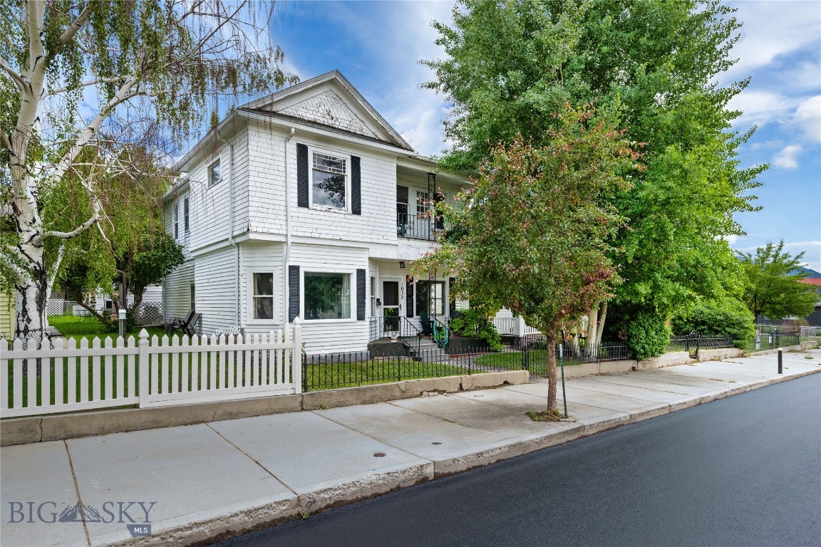 Charming historic home with flexible living options and duplex potential. The main level offers a comfortable one-bedroom, one-bathroom layout with a kitchen, living room, and spacious laundry room—perfect for single-level living. The upper level functions as a private secondary living space, featuring its own bedroom, bathroom, kitchen, and living room. It can be accessed by a private exterior entrance or through a recently installed spiral staircase from the main level, offering versatility for owner-occupants, guests, or rental opportunities. Enjoy views of the iconic Lady of the Rockies and surrounding mountain ranges, adding to the home’s charm. A private, fenced backyard with patio creates a peaceful outdoor retreat. There is also a single-level garage accessed from the alley. Full of character and classic appeal, this thoughtfully arranged home presents a rare opportunity for multi-generational living, income potential, or a unique single-family residence.