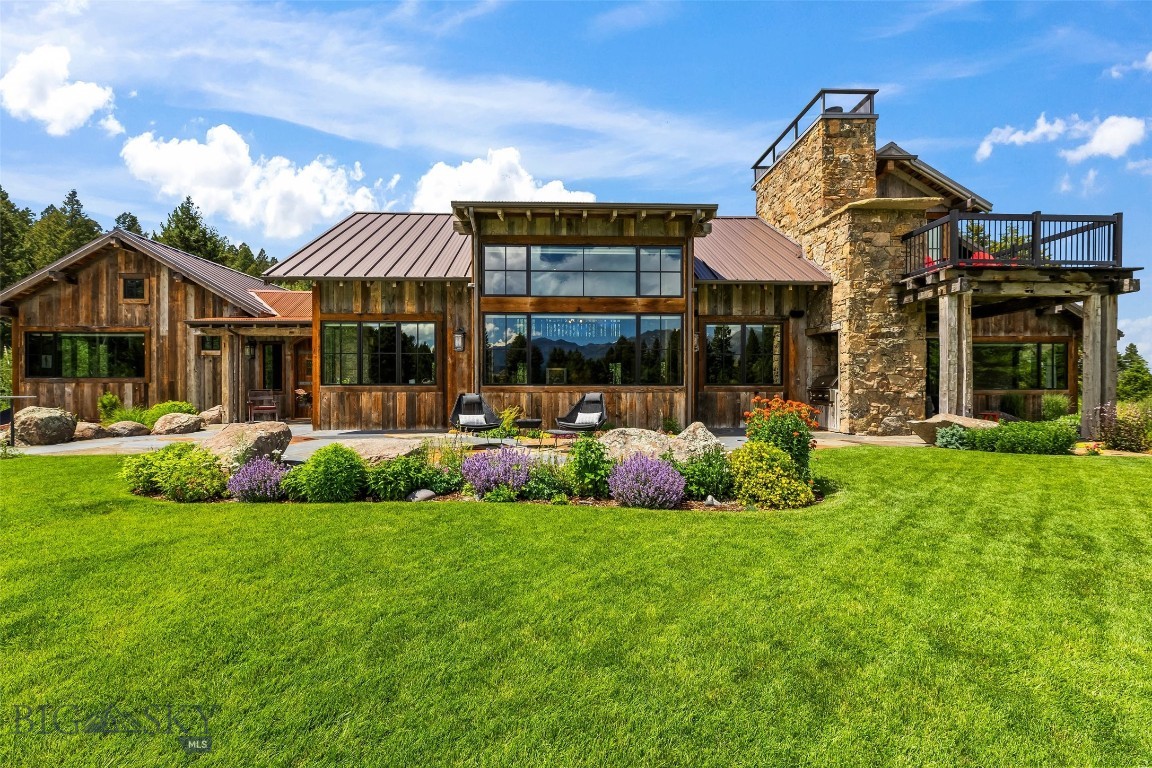 Set on 7 private acres within the exclusive Sun West Ranch, this extraordinary custom residence offers a rare combination of architectural excellence, timeless craftsmanship, and unparalleled Montana seclusion. Thoughtfully designed by renowned architect Keith Anderson and masterfully built by Mike McKitrick, the home showcases reclaimed barnwood, antique beams dating to the 1700s, hand-selected Montana stone, and exceptional artisan details throughout. Surrounded by more than 2,000 acres of protected ranch land and approximately 3.5 miles of the world-famous Madison River, this legacy property captures breathtaking mountain views with complete visual and auditory privacy. The expansive great room features soaring 23-foot ceilings, dramatic window walls, and a stunning wood-burning stone fireplace designed for everyday enjoyment. Custom artisan lighting, including a statement chandelier by acclaimed metal artist Kirsten Kainz, adds warmth and architectural significance. The chef’s kitchen is both elegant and functional, anchored by a solid Brazilian marble island, premium Thermador appliances, white porcelain countertops, The Galley workstation sink, and bespoke French oak cabinetry crafted by Crown Creations. Venetian plaster walls, reclaimed wood flooring, imported materials, and hand-forged hardware create a level of finish rarely found in Montana homes. The residence offers four bedrooms, four bathrooms, and a thoughtfully designed bunk room, along with multiple indoor and outdoor gathering spaces ideal for entertaining or quiet retreat. Nearly 40% of the home is lined with premium Pella windows, seamlessly blending indoor living with the surrounding landscape and flooding every room with natural light. Built for year-round comfort and effortless living, the property includes a high-performance HVAC system with whole house automated humidifier, whole-home Generac generator, smart-integrated lighting and blinds, Sonos audio system, high speed fiber optic installed, heated three-car garage, mudroom, and a detached custom storage structure designed to complement the home’s architecture. Sun West Ranch is one of Montana’s premier conservation communities, offering unmatched privacy, preserved open space, and direct access to world-class fly fishing, recreation, and wildlife in the heart of the Madison Valley. This is more than a home—it is a truly exceptional Montana legacy property.