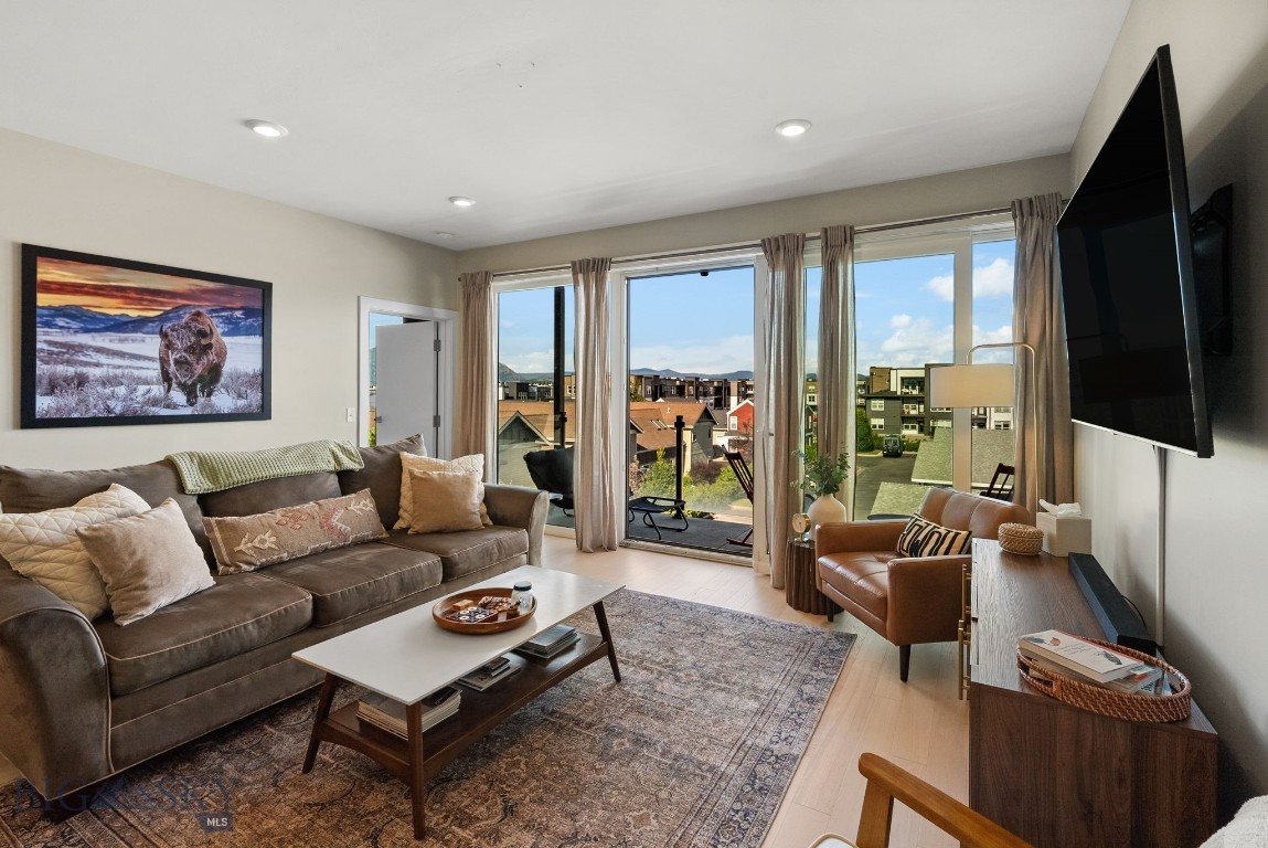 Rare top-floor corner unit at the stylish Talbach House, perfectly blending sophisticated modern aesthetics with the best of Bozeman living. This lightly-lived-in, 2-bedroom, 2.5-bathroom end unit offers an elevated lifestyle on Bozemans highly desirable south side. Step inside to an expansive, sun-drenched open layout flooded with glorious natural light. This premium unit features oversized, Euro-style floor-to-ceiling windows and doors that face east, treating you to spectacular morning sunrises over the mountain ranges while providing cool, shaded comfort in the afternoons. The gourmet kitchen is a chefs dream, boasting sleek quartz countertops, a contemporary design, and premium stainless steel appliances. The living space effortlessly extends through a large sliding glass door onto a private 4x8-foot deck. Both spacious bedrooms function as peaceful retreats, while the masterfully updated bathrooms feature luxury touches, including integrated Bluetooth LED mirrors. For ultimate comfort and peace of mind, the home includes central air conditioning and exceptional, building-grade soundproofing. Living at the Talbach House means enjoying a seamless, maintenance-free, lock-and-leave lifestyle backed by first-class community features including secure key-fob entry, an elevator-serviced building, and two separate on-site fitness rooms (one for cardio, one for yoga/relaxation). The unit includes one dedicated covered carport space and a private, lockable outdoor storage unit tailored for your skis, bikes, and outdoor gear. Perfectly situated directly across the street from the ponds and walking trails of Enterprise Park, you will enjoy unbeatable proximity to Montana State University (MSU), downtown Bozeman