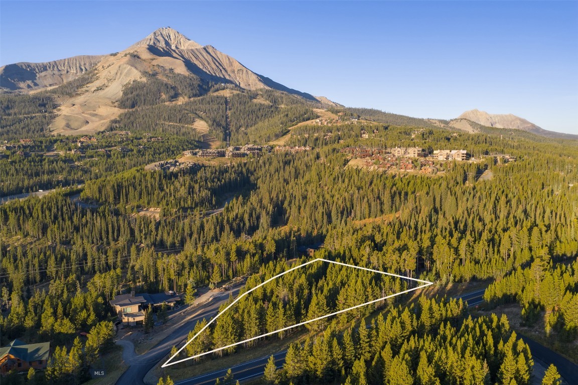 TBD Little Wolf (Lot 263) is a 1.055-acre homesite in Big Sky’s Cascade Subdivision where the views truly steal the show. Lone Peak rises up so close it feels like you could reach out and touch it, while Andesite Mountain and the surrounding forests create an unforgettable backdrop for your future mountain retreat. The lot features gently sloping topography with mature trees, offering both buildability and a natural sense of privacy. Nestled within an established neighborhood, it combines community with the feeling of being tucked away in the mountains.

Ski access is possible with a few road crossings, giving you the option to click in nearby, but the real appeal here is year-round. Whether it’s powder days, summer hikes, mountain bike rides, or evenings on the deck watching alpenglow settle on Lone Peak, this location makes it easy to live the Big Sky lifestyle. With its dramatic views, four-season recreation, and prime mountain setting, TBD Little Wolf is an exceptional opportunity to create your own basecamp in Big Sky. Don’t miss your chance to secure one of Cascade’s most captivating lots—reach out to your favorite Big Sky real estate professional to learn more.