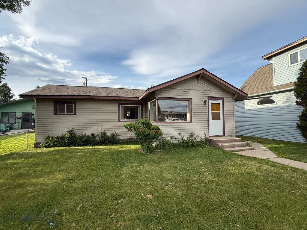 Welcome to this exceptionally well-maintained single-level home in downtown Butte. This inviting home features three bedrooms, a spacious living room, a versatile bonus room, a functional kitchen, a full bathroom, and a convenient laundry area—all on one level for comfortable everyday living. Step outside and enjoy the beautifully maintained front and back yards, both fully fenced offering the perfect space for relaxing, entertaining, gardening, or letting children and pets play safely. A detached garage provides convenient parking and additional storage, while the attached covered patio is an ideal spot to enjoy Montana's beautiful seasons.