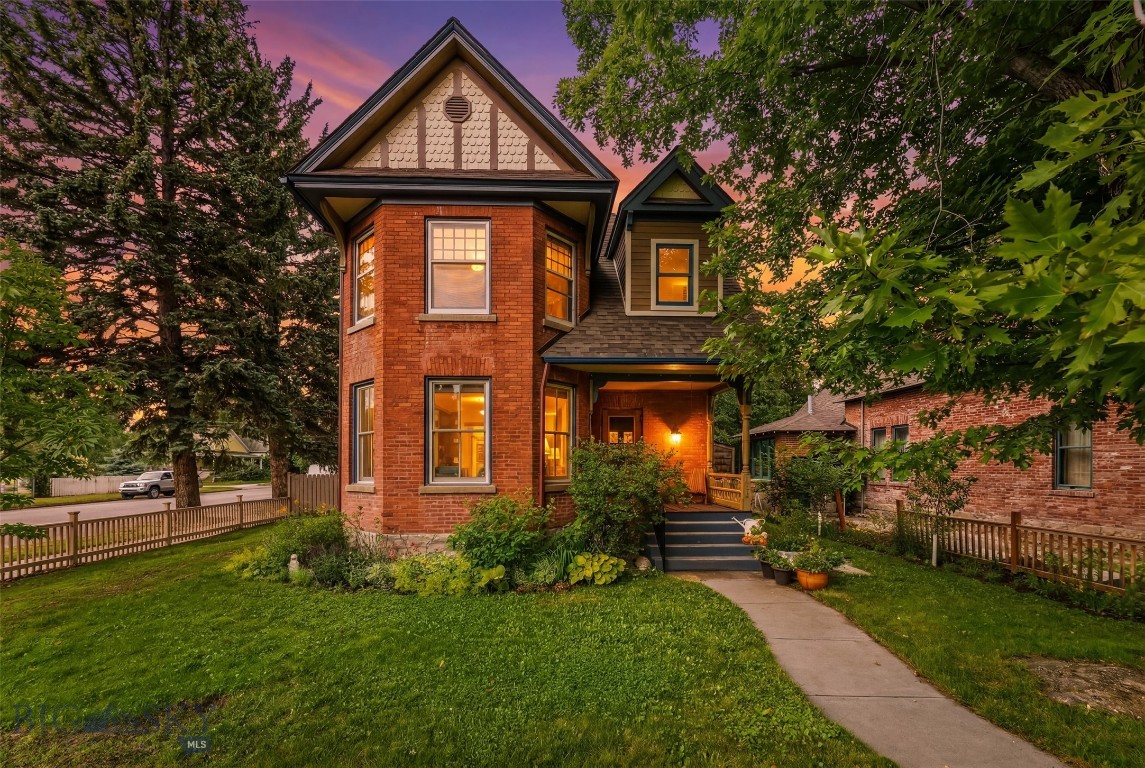 Some homes simply have a soul.

Built in 1885 and prominently positioned on a corner lot just a few blocks from downtown Livingston, this remarkable brick residence is one of the city's enduring historic homes. Wrapped in mature trees and perennial beds, the welcoming front porch invites you to slow down long before you step inside.

The interior blends timeless character with thoughtful updates. Original hardwood floors, high ceilings, oversized windows, and beautifully preserved woodwork create bright, elegant living spaces filled with natural light. The spacious living and dining rooms flow effortlessly together, anchored by a handsome fireplace and framed by windows overlooking the neighborhood. The kitchen connects to a cheerful breakfast nook that opens onto the private back deck, and the powder room off the kitchen showcases an exposed brick accent wall that quietly celebrates the home's history.

Upstairs you'll find three bedrooms, including an expansive primary suite with a conveniently located stacked washer and dryer, a dedicated office perfect for working from home, and a full bath.

The finished lower level offers exceptional flexibility with a large bedroom, full bathroom, kitchenette, and an additional bonus room—ideal for guests today with exciting potential for a future income-producing suite.

Outside, the backyard feels like a private retreat. Entertain beneath the trees on the spacious deck, unwind in the cozy standalone sauna after a Montana ski day, gather fresh eggs from the charming chicken coop, or simply enjoy the lovingly maintained yard, complete with many varieties of fruit trees.  A detached garage completes the property.

Important improvements include a new roof and front dormer (2020), updated electrical throughout, first-floor windows (2024), brick repointing (2025), new water service (2026), updated sewer line (2017), and a dedicated 220-volt line for the sauna.

This is more than a beautiful historic house—it's a home that has been carefully preserved, thoughtfully improved, and lovingly lived in. Opportunities to own a property like this, in one of Livingston's most walkable and sought-after neighborhoods, rarely come along.
