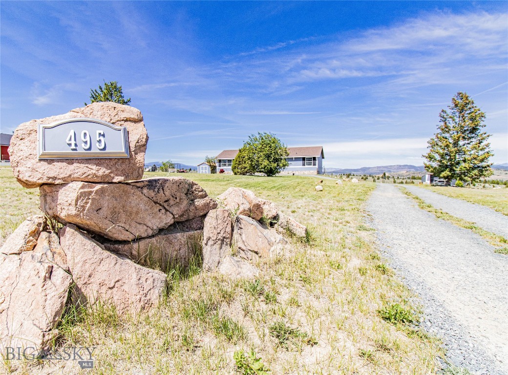 Situated on just over 1.4 acres, this well-maintained home with a walk out basement offers 3 bedrooms including a recently updated master suite on the main level, an absolutely gorgeous kitchen with tons of cabinet space, a large dining area and separate living room.  The second and third bedrooms are both large enough for king size beds and the second full bathroom is located between them, just off the living space.  Head outside onto the newer second story deck and unobstructed views for miles.  The backyard can be accessed from the deck or from the walk out basement where you'll find a very large bedroom, 3/4 bath, huge storage room, and a family room that encompasses about half of the downstairs square footage, if not a little more.  There is a fenced area for dogs or kids directly behind the home and a covered patio.  The hot tub is negotiable.  The back yard slopes down towards privately owned land behind, and you can enjoy your evening sunsets around the firepit near the back of the property.  Outside there is a shed and a chicken coop that could also be used for a dog run.  The home sits back from Lupine Lane with a circular driveway and feels very private.  Overall, this 2006 house will wow you with its roominess, views, and updates!