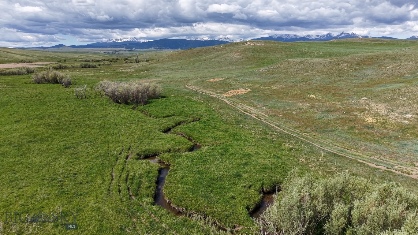 Norwegian Creek 480 is part of the historic 126+ year-old Maichel Ranch, located just outside of Harrison, Montana. Set beneath the Tobacco Root Mountains and just upstream from Harrison Lake, this 480-acre property offers 1/2 mile of creek bottom privacy, open space with huge views, and strong potential for an equestrian estate, small ranch, or private retreat.

The land consists of three 160-acre legal parcels with multiple building sites ranging from private, wooded creek areas to open hilltops—all offering sweeping 360-degree views. The property borders a 640-acre section of State land with another mile-plus of Norwegian Creek frontage, further expanding recreational access and ensuring an extremely private setting with no other homes in view.

Over 200 acres of the property can be farmed or cropped separately for food plots, grain production, or other agricultural uses. Elk, deer, upland birds, and other wildlife are frequently seen on the land, enhancing its appeal for hunting and outdoor enjoyment.

Located at the end of the road on the historic Maichel Ranch, the property provides excellent privacy with convenient access—just 45 minutes to Bozeman and 20 minutes to Ennis. Nearby power and road improvement materials can be made available by the seller with an acceptable contract, offering additional development flexibility. Seller offers to lease property for grazing purposes to create cash flow for new owner.

Generations of careful stewardship are reflected in Norwegian Creek 480’s productive capacity and natural beauty, making it a rare opportunity in southwest Montana.