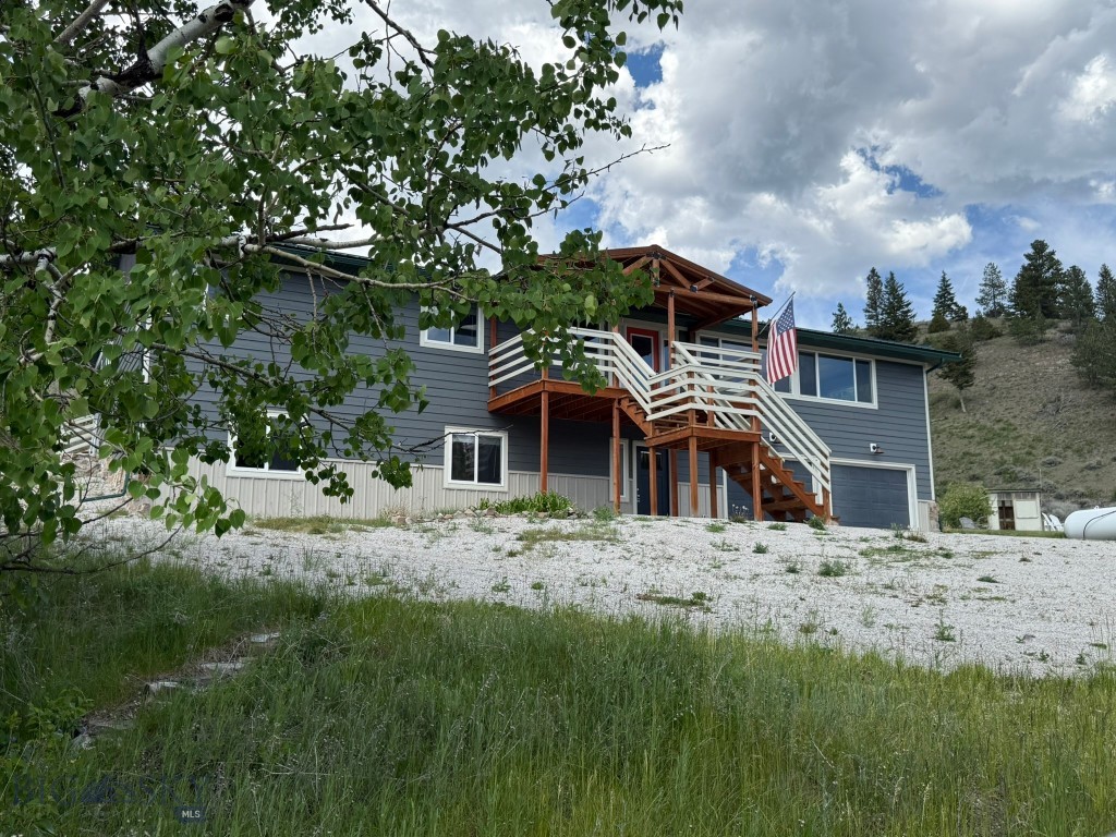 Looking for privacy, water and a refreshingly new, updated home?  Look no further!  11 Upper Greyson Creek Road offers 200+/-feet of creek frontage plus 19 +/- acres for your fishing & hiking enjoyment.  Impressively and lovingly remodeled from top to bottom in a 2021-2022 rebuild, this like-new 5 bedroom, 3 bath home has been used as a private residence as well as a popular short term rental. Located in a beautiful setting with mountains, canyons, and privacy galore, you'll love the views along with a spacious, open floor plan. Walk into the ground floor level (walk out basement) and you'll find two large bedrooms, a full bath, plus a game room with air hockey, board games and TV.  Head upstairs to discover a spacious open living room, dining area and chef's kitchen with cooking island and bar, perfect for entertaining dinner guests! Views from the large picture windows are simply stunning!  Down the hall is a fabulous primary suite with sliding glass doors inviting you outside to a wrap around deck.  The primary suite includes a state-of-the-art dream bathroom complete with custom tiled shower, separate deep jetted soaker tub, dual sinks with LED light up faucets, plus two more bedrooms and a half bath down the hall.  All closets in the home have been equipped with LED automatic lights which turn on when door is opened. Ample outside deck wraps around from side to back and is great for barbeques, while the firepit is ready for stories, laughs and s'mores! Take off for a four wheeler ride to State Land just down the road or take a hike on the acreage and catch a brook trout in Greyson Creek. Move in and start enjoying your vacation home, vacation rental, retirement home or your forever home! It includes an oversized double car garage with large workshop room in the back, but you can always build an additional shop for all your toys or a barn for your animals because there is plenty of room. You'll love the rural wooded, private feel of this property but you'll also enjoy the close proximity to Canyon Ferry Reservoir, Townsend (15 miles) or Helena (49 miles) or Bozeman (72 miles) for bars, restaurants, shopping, medical services or airports.