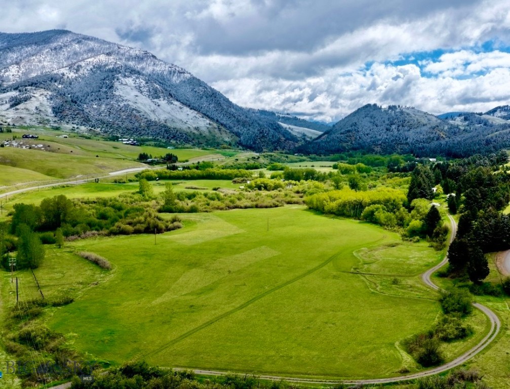 At the base of Bridger Canyon, 3.3 miles from Main Street in downtown Bozeman, this exceptional 36.954± acre property offers a rare combination of privacy, spectacular views, and investment potential. With over 2,200 feet of Bridger Creek frontage, fertile irrigated farmland, mature timber, abundant wildlife, and valuable stock & irrigation water rights, the land itself is the true centerpiece and primary value of this offering. Tucked into the trees on the upper bench are a homestead log home and two large detached shop buildings, providing a functional base while leaving endless opportunity to create a legacy estate, ranch, or retreat in one of Bozeman’s most sought-after locations.