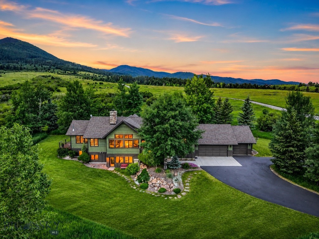Discover refined Montana living in this beautifully updated custom home, ideally located in the prestigious Eagle Rock Reserve. Near the end of a quiet private road, this exceptional property offers unparalleled privacy and direct access to thousands of acres of adjacent public land, creating a true outdoor paradise. Residents enjoy exclusive access to approximately 750 acres of private shared land, featuring scenic trails, a horse facility, subdivision ponds stocked with trout, and breathtaking panoramic views of surrounding mountains and forest. The area is teeming with wildlife year-round, offering an immersive Montana experience right outside your door. Inside, you’ll find three spacious bedrooms and five updated bathrooms, each showcasing meticulous attention to detail. The heart of the home is an expansive great room anchored by a dramatic stone wood-burning fireplace. Soaring ceilings with handcrafted beams, circle-sawn wood flooring, and in-floor radiant heat add warmth and character to the main level. The newly remodeled gourmet kitchen is a chef’s dream, featuring quartz countertops, Wolf range, a walk-in pantry, and refined touches such as toe-kick lighting. Just off the kitchen, a sun-drenched four-season room with a cozy gas fireplace provides the perfect retreat to enjoy Montana’s changing seasons and wildlife viewing. Also on the main level, you'll find a generous home office, a ¾ bath and a well-appointed laundry room designed for everyday convenience. The luxurious primary suite is a private sanctuary, offering walk-out deck access, a gas fireplace, and a spa-inspired bathroom complete with a soaking tub and modern finishes. The walk-out lower level features a spacious family room, a dedicated theater/media room, and two additional bedrooms, including one with an en-suite bath. All three lower-level bathrooms have been tastefully renovated with custom cabinetry, designer tile, toe-kick lighting, and two baths have heated floors for added comfort. A dedicated hobby shop and steam shower room are also located on this level. Additional highlights include a heated three-car garage, new windows, new cedar siding, new roof shingles, and a long list of premium upgrades completed within the last four years. Every element of this home reflects exceptional craftsmanship and a deep appreciation for quality. This is a rare opportunity to own a truly distinctive property in Eagle Rock Reserve.