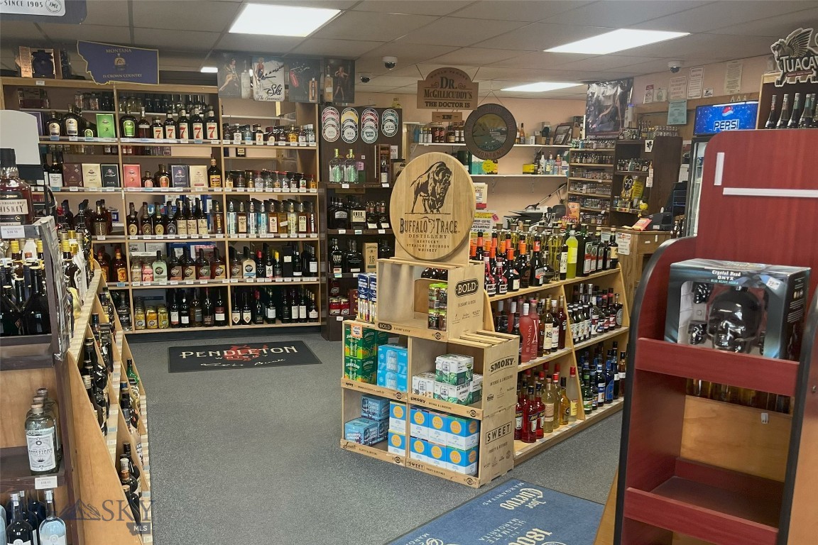 Located in the growing Helena Valley market, this established state agency liquor store presents a rare opportunity to acquire a turnkey retail and wholesale liquor operation with real estate included. Situated at 108 S Lane Avenue in East Helena, Montana, the offering includes a 2,560-square-foot commercial building positioned on a 14,462-square-foot lot with strong accessibility and on-site parking. The business operates as a Montana Agency Liquor Store, a state-contracted operation authorized for the retail sale and wholesale distribution of distilled spirits and fortified wines. The sale includes the real estate, liquor license, existing wholesale distribution relationships, inventory, and furniture, fixtures, and equipment, creating an attractive opportunity for an owner/operator, regional liquor retailer, convenience store operator, or hospitality group seeking immediate operational capacity in the Helena market. The building features a functional layout with dedicated retail and storage areas designed to support both customer-facing sales and wholesale distribution operations. With limited opportunities to acquire Montana agency liquor store operations with accompanying real estate, this offering combines business value with long-term real estate ownership in one of Montana’s steadily expanding communities. Offered at $2,700,000, the property provides the ability to step into an established operation with existing infrastructure, licensing, and distribution channels already in place.