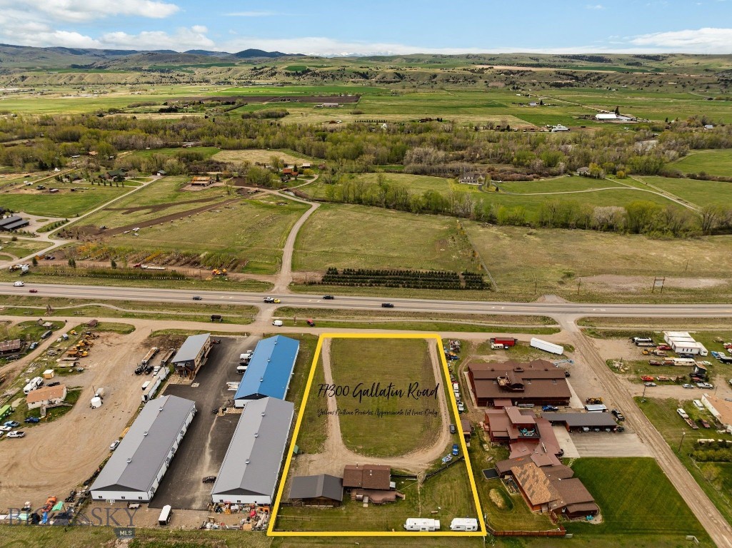 Direct highway frontage in one of the area's highest daily traffic counts, 77300 Gallatin Road is situated on Hwy 191 connecting Bozeman to Big Sky. This 1.73-acre property offers a combination of residential & commercial functionality, delivering exceptional visibility & accessibility as a long-term value in one of Bozeman, Belgrade, & Big Sky's fastest-growing corridors. Income potential is turn-key provided by the existing 2,020 sq ft log home (ideal for residential or office conversion) and 1,1014 sq ft, 3-car garage providing owner-operator or on-site management, while the expansive, flexible, open acreage provides an immediate opportunity for contractors, trades, or small business operations, & development. The property’s 1.73-acres significantly enhances 77300’s investment opportunity with a layout that could support warehouse/storage development, commercial/multi-family build out, equipment storage, service-based businesses, or live/work configurations & development into a full-blown commercial/light industrial property. Locationally only ~15 minutes to Bozeman, ~35 minutes to Big Sky Resort, & maintaining direct access to one of Montana's most traveled corridors, this is a rare opportunity to secure a flexible, highly-visible asset in the heart of Gallatin Valley’s direct path of growth. Properties like 77300 Gallatin Rd have become increasingly difficult to replicate as local inventory of small-acreage, high-visibility parcels continues to tighten & are historically incredibly limited in number. Squarely seated in the line of notable commercial exposure, where the demand for commercial and hybrid-use property continues to outpace supply, this acreage proves highway frontage, usability, contributory value of improvement, income potential & a flexible zoning/use profile. As growth continues to push South from Bozeman and North from Big Sky, this acreage sits in a narrowing window of opportunity offering significant potential for contractor and/or service-based businesses, live/work residence for on-site operations, equipment storage/staging, logistics yard space, other commercial/multi-family build out plans, & simply a long-term hold for current or future additional development as its corridor density ever increases. The combination of exposure, flexibility, and future scalability offer an owner-users unlocked value for highest and best use as a commercial or hybrid investment. Call today for a private showing.