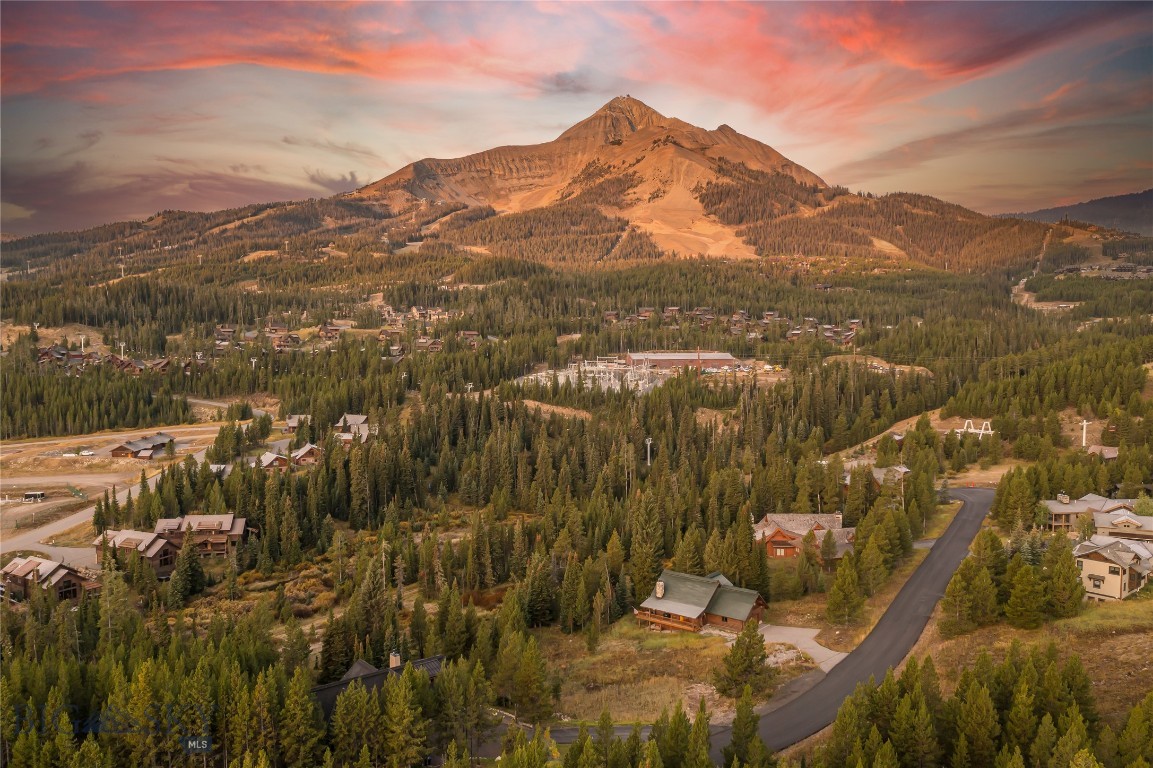 Discover an extraordinary opportunity to build your dream home in the mountains on this premier ski-in/ski-out homesite in Big Sky, Montana. This nearly one-acre Big Sky Resort parcel is perfectly positioned to capture panoramic mountain views, with exceptional sun exposure that bathes the property in natural light from sunrise to sunset.

Set within one of Big Sky’s most secluded yet easily accessible slopeside communities, the property offers direct ski access via the White Otter Chairlift at Big Sky Resort—a rare privilege for both adventure seekers and those who appreciate true ski convenience. Just outside your door, you’ll find access to nearby trails, a meandering stream, and endless opportunities for four-seasons of recreation.

From this private retreat, you’re only minutes away from the expanding amenities of Big Sky’s Mountain Village (5 minutes), the vibrant Town Center (10-15 minutes), world-class fishing on the legendary Gallatin River (20 minutes) and beyond to Bozeman and Yellowstone National Park (60 minutes). Whether you envision designing a modern mountain lodge, a rustic alpine escape, or a legacy home for generations to enjoy, this site ready to bring your dream to life.

With its rare combination of privacy, accessibility, and unmatched natural beauty, this stunning ski-in/ski-out homesite is more than land—it’s the foundation for your future in the heart of Big Sky.