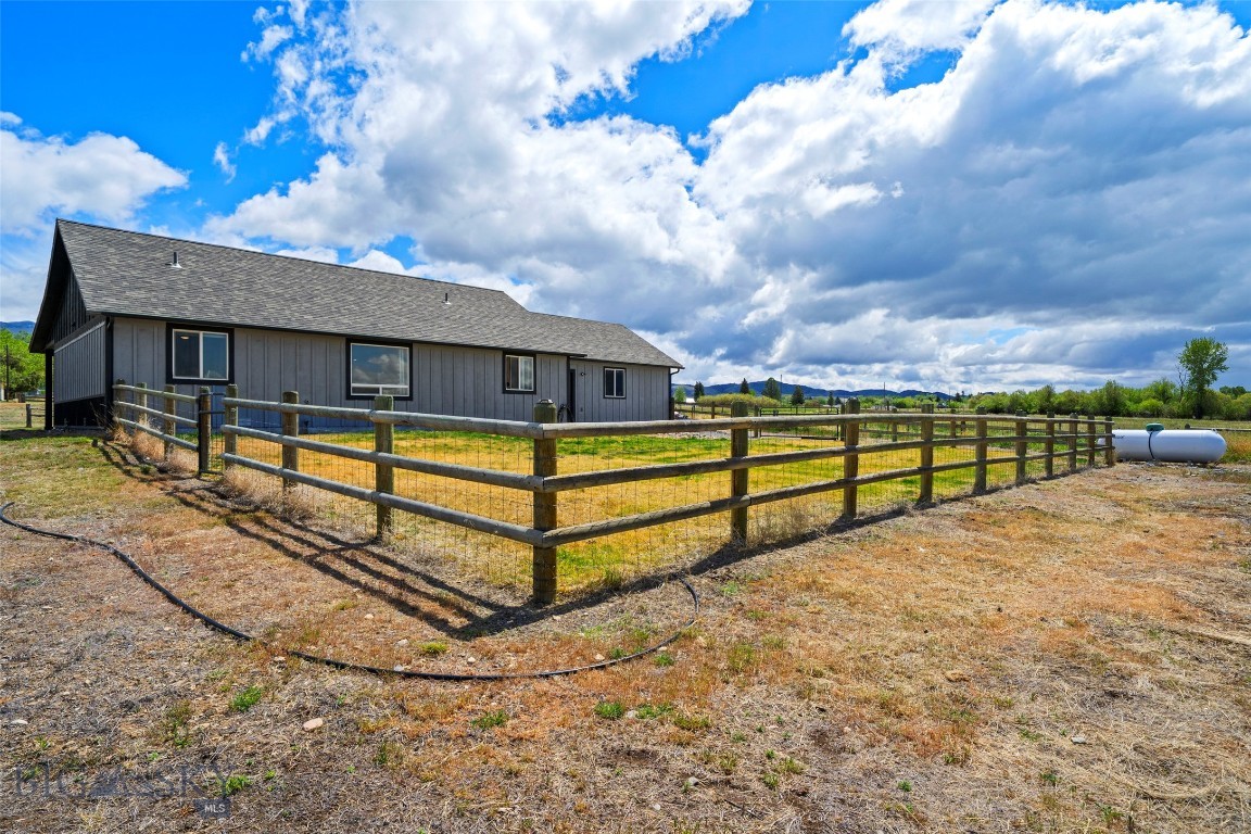 Like-new 2018 ranch in the heart of the Ruby Valley with Tobacco Root Mountain views and Ruby River bottom right out the back. Soaring tongue-and-groove cedar ceilings  set the tone in a true great room layout — open kitchen with maple cabinetry, stainless appliances, center island, and a window over the sink framing the mountains. Three bedrooms, two full baths, all on one easy-living level. Primary suite in its own quiet wing with mountain views and private bath. Two additional bedrooms or flex/hobby room. 2-car attached garage, deep covered front porch, and a partially fenced .54-acre lot with room for a few animals. Minutes to downtown Sheridan, blue-ribbon trout water on the Ruby and Beaverhead, Tobacco Root trailheads — just over an hour to Bozeman. Turnkey and ready for the right Montana doorway to open. Seller is related to the Broker.
3 BD | 2 BA | 1,472 SF | Built 2018 | .54 Acres | 2-Car Garage