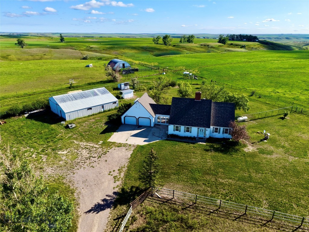 The ground is currently leased for cattle, demonstrating its proven capacity to support livestock while offering immediate income potential for a new owner.
Supporting the operation is an impressive lineup of outbuildings and ranch infrastructure. A 40’ x 40’ Quonset, 36’ x 50’ shop, horse barn, chicken coop, greenhouse, fuel stands with tanks, and multiple storage buildings provide ample space for equipment, livestock care, feed, and projects of every scale. Whether your vision includes expanding a cattle operation, establishing a hobby farm, or simply enjoying the freedom of rural living, these improvements add tangible, hard-to-replace value.
At the center of the property sits a home that has been completely reimagined inside, offering modern systems, elevated finishes, and timeless character. The kitchen stands as a true focal point—designed for both functionality and gathering—featuring a six-burner propane Viking range, built-in microwave, and a double-drawer Café dishwasher, paired with butcher block countertops, sleek cabinetry, and high-end appliances throughout. It’s a space built for those who value both serious cooking and everyday comfort. Beyond the kitchen, a long list of upgrades includes a new reverse osmosis water system, new furnace and air conditioning, on-demand hot water heater, new flooring throughout, and a new well pump and controls. Original details add warmth and character, including a refinished wood staircase, wood and pellet stoves, and a whitewashed brick fireplace.
Beyond the property lines, the Vaughn area offers exceptional outdoor recreation and lifestyle appeal. The nearby Sun River and Missouri River provide outstanding fishing and floating opportunities, while wildlife areas, open landscapes, and Montana’s renowned hunting districts surround the region. Just minutes away, Great Falls offers healthcare, shopping, dining, cultural attractions, and a commercial airport with direct flights to major hubs—making this location as convenient as it is peaceful.
This property is a place where the land works, the home comforts, and the lifestyle delivers exactly what so many are searching for.