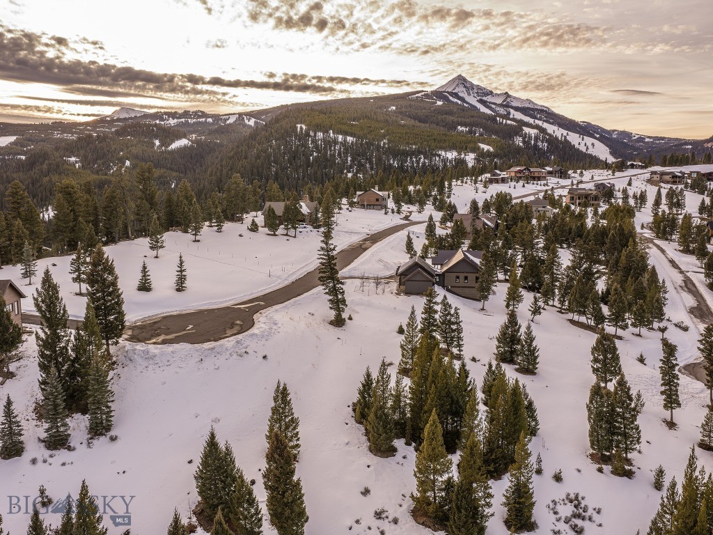 Antler Ridge Lot 128 provides a canvas for an extraordinary mountain retreat, where open skies, protected landscapes, and alpine beauty converge. Bordering nearly 200 acres of preserved open space and seamlessly linked to 85 kilometers of Nordic ski trails, this remarkable homesite invites a lifestyle shaped by both serenity and adventure. Sweeping eastern vistas unfold with ample morning light, while to the west, framed views of Lone Peak provide iconic Montana grandeur. Perfectly positioned between Big Sky’s Mountain Village and the convenience of the Town Center, the property offers effortless access to world-class downhill skiing, dining, and boutique shopping just four miles away. Homesite 128 at Antler Ridge is more than land—it is an invitation to create a legacy mountain home in one of the West’s most coveted resort settings.