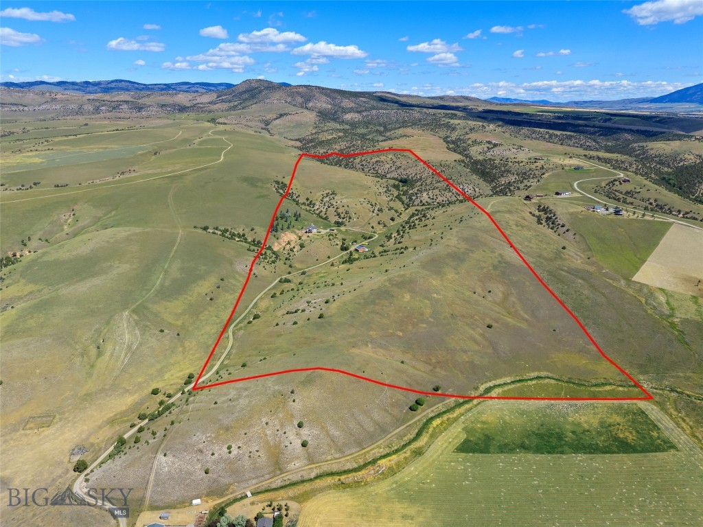 Set on 140± acres of open rangeland northwest of Belgrade, Hidden Spring Hills offers a rare chance to own a vast and unspoiled piece of the Gallatin Valley—an increasingly scarce opportunity in a region undergoing rapid development. This land is the main event: wide horizons, unobstructed mountain views, and a quiet that speaks to what Montana once was. Minimal covenants. No HOA. No commercial encroachment. Just space, sky, and possibility.
Beautiful rolling acreage with water rights (a 350 gpm irrigation well stands ready for a future owner to put water to work) and southern exposures offers pasture land for horses and livestock as well as space for all of your recreational needs– horseback riding through sunlit meadows, hiking hidden trails, sledding down snow-covered hills, cross-country skiing, or quietly observing the rhythm of wildlife in every season. Develop your own trails or follow the game trails that take you past distinctive rock outcrops, a small hidden natural spring, ravines and meadows sheltering wildlife, birds, flowers, and native grasses. 
At the heart of the parcel stands the historic Quaw Mansion– a Queen Anne landmark built in 1892 and relocated here decades ago as part of a preservation effort. The structure has been stripped to the studs and has roughed in plumbing and electrical. Its architectural bones and period details remain, waiting for a future owner to restore its legacy or reimagine its footprint. A fully finished walk-out basement provides comfortable living quarters while plans for the upper levels take shape. A detached 40'×40' shop adds valuable space for equipment, toys, or staging a renovation.
Indulge in blue-ribbon fishing on the East Gallatin River, just three minutes away, or plan an adventure into the nearby Gallatin National Forest, offering big game hunting and camping. From the homesite, take in spectacular views overlooking the East Gallatin and the rural farms and ranches that sweep outward to meet the majesty of five surrounding mountain ranges.
With its scale, privacy, water, wildlife, and storied past, this property is ideal for someone seeking solitude, long views, and a tangible connection to the valley’s heritage—before the subdivisions, before the traffic, before the sprawl. Whether preserved, rebuilt, or redefined, the land speaks for itself.