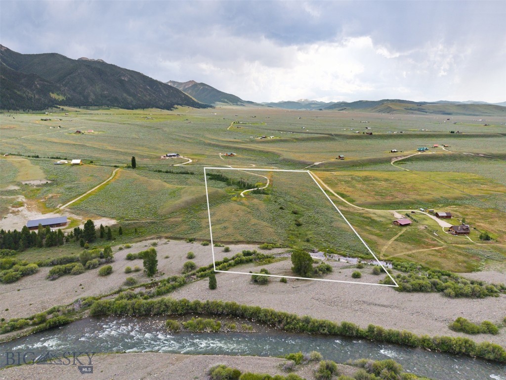 Experience the privacy and recreation that define Montana living on this exceptional 20 acre parcel in Sportsman's Paradise. Bordering U.S. Forest Service land, the property provides walk-in access to the Madison River, where this stretch is designated for wade fishing only, creating a peaceful setting without drift boat or raft traffic. Sheep Creek flows through a portion of the property, enhancing the landscape and attracting abundant wildlife. A driveway and culvert crossing have already been installed, along with power, a high producing 53 GPM well, and septic approval, giving you an outstanding head start on building your Montana retreat. While neighboring homes are nearby, the surrounding public land and natural setting provide an exceptional sense of privacy. Outdoor recreation is at your doorstep with Sheep Creek and Mile Creek trailheads nearby, along with Hebgen Lake, Quake Lake, Cliff Lake, Wade Lake, Henrys Lake, and thousands of acres of surrounding public land. Whether your passion is fly fishing, hiking, horseback riding, hunting, snowmobiling, or simply enjoying wide open spaces, this location places you in the heart of it all. Big Sky, West Yellowstone, Yellowstone National Park, Island Park, and Ennis are all within approximately an hour. Sportsman's Paradise allows short-term rentals, providing flexibility for a private residence, seasonal getaway, or investment opportunity. Opportunities to own acreage with power installed, a 53 GPM well, septic approval, Sheep Creek, and walk-in Madison River access through adjoining U.S. Forest Service land are few and far between. Come experience the quiet beauty and unmatched recreational lifestyle this property has to offer.