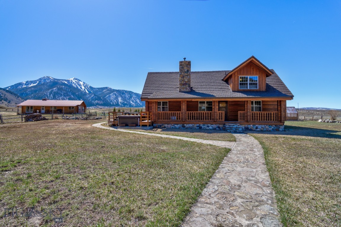 MADISON RIVER is just a stones throw away!  Charming 3-bedroom, 2-bath log home comes with a fully furnished 4-bedroom guest cabin and private walking access to the legendary Madison River, perfect for some of the best wade fishing you'll find on the upper Madison. The property also borders Sheep Creek and sits on over 20 acres of gorgeous Montana landscape, with stunning mountain views from the front and side decks.

The main house is warm and welcoming, featuring a spacious great room with vaulted ceilings, a beautiful rock fireplace, and an open kitchen and dining area with new Anderson sliding doors that lead out to the deck—ideal for relaxing or entertaining. On the main level, you'll find two bedrooms and a full bath, while upstairs includes the primary suite, an additional loft bedroom, and a cozy loft area.

The 1,248 sqft guest cabin is powered by a solar system and split into two fully furnished units with a total of 7 beds and 2 kitchenettes, great for hosting family or renting out short- or long-term. 
There's also a large detached garage/shop with a utility room, plus two bonus rooms that can be used as offices, craft spaces, or extra guest rooms, each with their own bathroom. Outside, you'll find mature landscaping, a greenhouse, and fenced pastures with classic jack leg fencing.
This is a rare opportunity to enjoy space, views, and direct river access all in one spot!

Approximately 40 miles South of Ennis, located on the edge of the Lee Metcalf Wilderness area just down from Quake Lake and close to Cliff and Wade Lakes. Just miles from West Yellowstone, the western gate to Yellowstone National Park.  Henry's Lake is a few miles down the road and Henry's Fork is ten miles further.  
This is a great property along with an amazing place to live!!