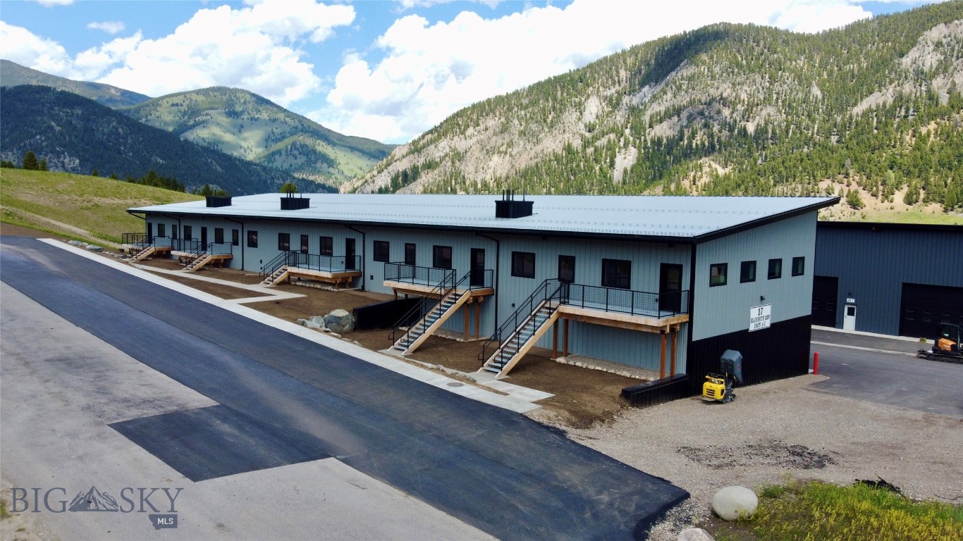 New Big Sky warehouse offering that includes contingeous units C, D & E as a package deal. Totaling 8,500 +/-SqFt, the unit walls can be removed to open up the space to customize as needed allowing for over 5,320 Sqft of main level space.  This is an excellent opportunity for investors seeking income-producing commercial property in a high-demand Big Sky market. Each individual unit is roughly 1,800 SqFt on the main level and a 900 SF mezzanine with a separate rear entrance and parking. This mezzanine layout is ideal for offices above and expansive storage below for safeguarding valuable tools, equipment, and gear from Montana’s harsh elements. Each unit includes a private bathroom, ducted heat, utility sink with hot and cold water, and a 14’ roll-up door. The main level boasts a generous 13’9” ceiling height, maximizing usable space. Whether you