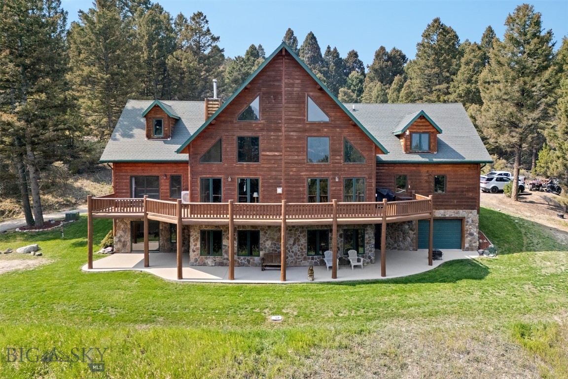 Tucked among towering pines, dramatic rock outcroppings, and sweeping mountain views, this extraordinary Montana retreat offers over 16 private acres of breathtaking natural beauty just minutes from Butte.
Designed to embrace its remarkable surroundings, this custom-built estate combines rustic elegance, exceptional craftsmanship, and the peaceful seclusion of true Montana living. Expansive windows throughout the home frame stunning valley and mountain vistas while filling the living spaces with natural light.
At the heart of the home, the soaring great room features impressive 28-foot ceilings, rich wood accents sourced directly from the property, and a striking floor-to-ceiling rock fireplace that creates a warm and inviting gathering space. The spacious layout offers nearly 6,000 square feet of living space, including 5 bedrooms, 3 bathrooms, multiple gathering areas, a private office/den, and a versatile bonus room ideal for a media room, fitness space, or additional guest accommodations.
The luxurious primary suite serves as a private retreat with its own rock fireplace, spa-inspired bathroom featuring a jetted soaking tub and walk-in shower, and generous closet space.
The walk-out lower level is perfectly designed for entertaining or multi-generational living, complete with a full second kitchen, spacious family room, additional bedrooms, and direct outdoor access.
Outdoor living is equally impressive, with expansive decks and covered gathering spaces designed to take full advantage of the surrounding landscape, wildlife, and panoramic views. Whether enjoying quiet mornings surrounded by nature or hosting guests under Montana’s endless skies, the property offers a rare sense of privacy and tranquility.
Additional features include radiant floor heating, newly installed mini-splits, beautifully landscaped grounds with underground sprinklers, two separate attached garages with ample room for vehicles, storage, and recreational equipment, and an ideal balance of luxury and functionality throughout.
More than just a home, this is a private Montana mountain sanctuary where comfort, craftsmanship, and nature come together to create an unforgettable living experience.