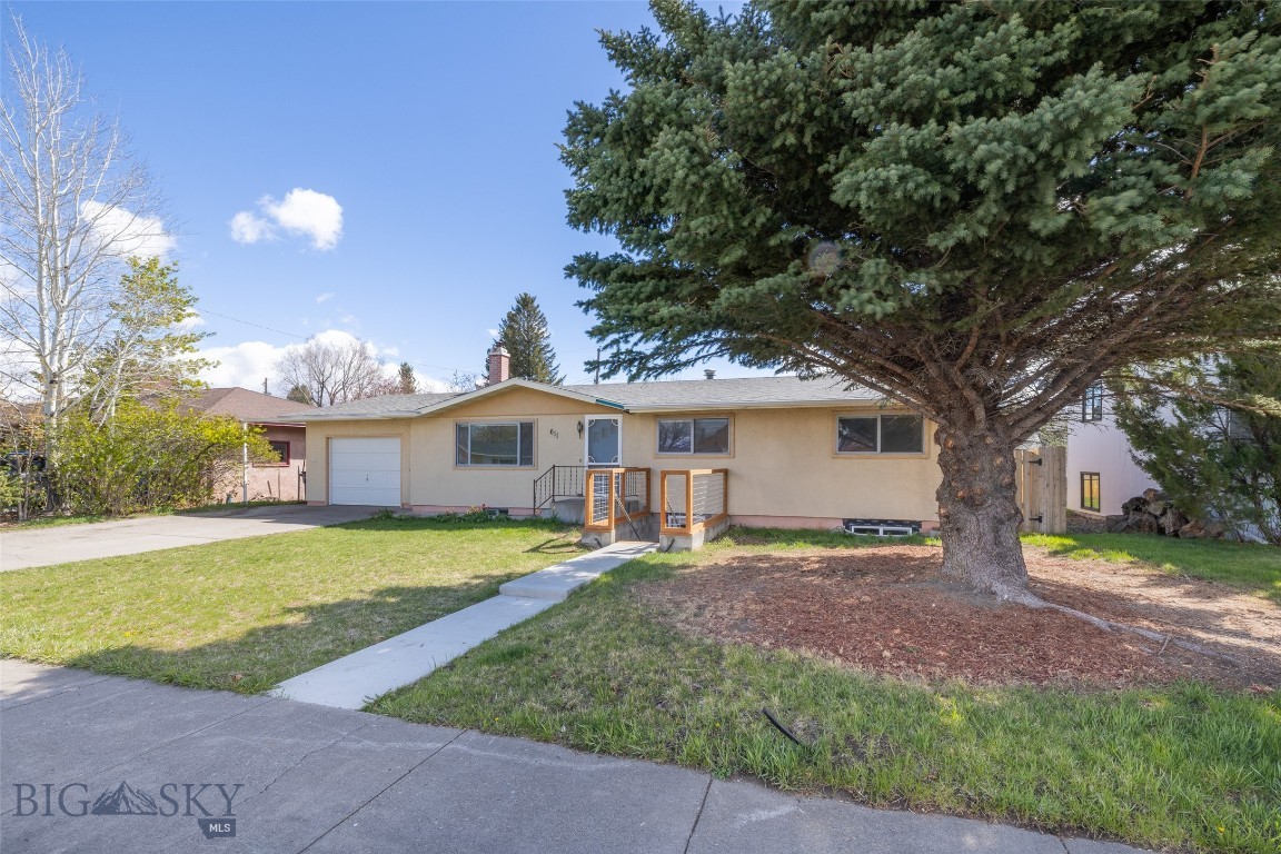 This solid 1972 home sits in one of Livingston's most practical southside neighborhoods—close to grocery stores and schools. It's the kind of location that works whether you're raising a family, commuting, or looking for a property that pulls its own weight.
The main level offers three bedrooms and two bathrooms with a functional layout that feels bigger than the square footage suggests. The open kitchen and dining area flow out onto a back deck overlooking a large, fully fenced yard with a mature apple tree—the kind of outdoor space that gets used. Original hardwood floors in the dining area are in great shape. A stackable washer/dryer is conveniently located on the main floor, and the living room has plenty of room to stretch out and relax.
The basement apartment has an interior entrance plus its own separate exterior entrance. A kitchenette, two bedrooms (one non-egress), a 3/4 bath, a large family room, and its own laundry, storage space, and mechanical room. It's a clean, self-contained space—currently set up for a tenant or extended family, but easy to open back into the main home if preferred. The rental income potential here is real and worth running the numbers on.
The attached garage is single-car but over-sized with a workshop area that makes it genuinely useful for a hobbyist or someone who needs a dedicated project space. Stucco siding keeps exterior maintenance low, and a new roof was installed in 2023—two less things to think about.
This is a move-in ready home with options baked into the floorplan. Whether you're looking for a primary residence with offset income or a long-term investment in a stable Livingston neighborhood, this one checks the boxes without requiring imagination to see the value. Interior photos are virtually staged to show the potential of this well laid out home.