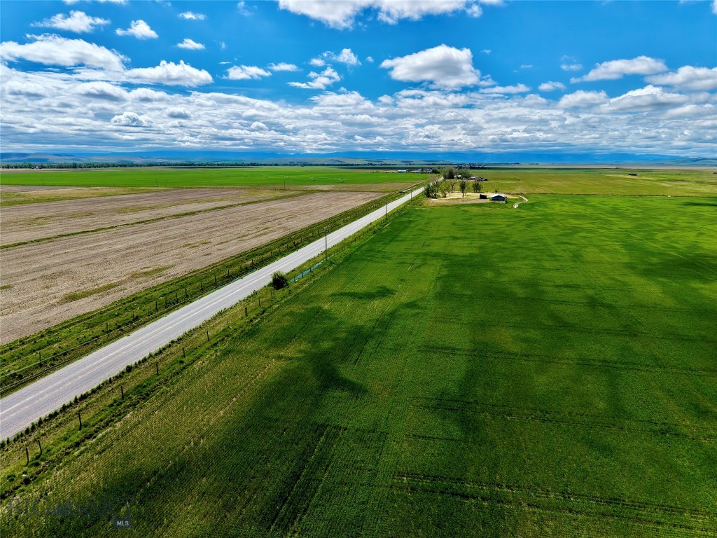Set against the wide-open beauty of Montana’s prairie and within close reach of the stunning Rocky Mountain Front, this 10.53-acre property near Bynum invites you to build in a location where acreage is nearly impossible to find. With sweeping country views, established trees, existing improvements, and essential groundwork already in place, this acreage presents an exceptional opportunity for buyers looking for a future homesite, recreational basecamp, or peaceful rural retreat. The property includes power, fiber optic, telephone service, two wells, an existing septic tank of unknown location and condition, and a barn, giving buyers a strong starting point for their Montana vision. The trees and open ground create a welcoming sense of place, offering shelter and shade. From here, adventure is never far away. The nearby Rocky Mountain Front rises to the west, offering endless opportunities for hiking, fishing, wildlife viewing, skiing, camping, and exploring. Bynum Reservoir, the Teton River, Gibson Reservoir, the Blackleaf Wildlife Management Area, the Bob Marshall Wilderness, Teton Pass Ski Area, and Glacier National Park are all part of the larger landscape that makes this area so treasured. Choteau is also close by for groceries, supplies, dining, and small-town conveniences. For the sportsman, this area is especially appealing. The surrounding farm fields, draws, coulees, and native habitat support excellent upland bird opportunities, including pheasant, Hungarian partridge, and sharp-tailed grouse. Big game hunters will appreciate access throughout the region to multiple state and Montana public lands, with nearby habitat supporting mule deer, whitetail deer, elk, antelope, and other wildlife associated with the Rocky Mountain Front. This is a place where mornings can begin with birds lifting from the grass, afternoons can be spent glassing distant ridgelines or casting into nearby waters, and evenings can end beneath a sky full of stars. Build here, roam from here, and enjoy the best of the Front.