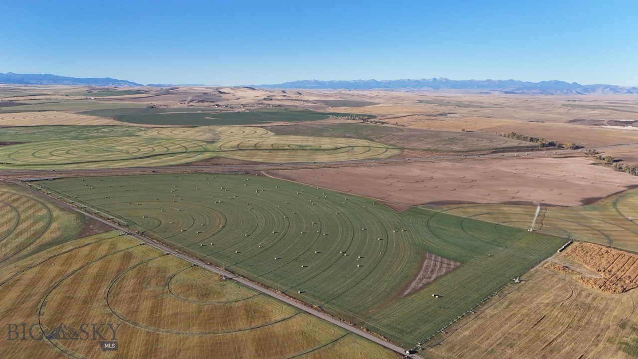 NO COVENANTS OR ZONING! Creative Seller - Bring your ideas!! 84+ beautiful acres of farm land just minutes outside of Manhattan. 360 degree views of the mountains and surrounding hillsides. Incredible opportunity for business and commercial use as well with I-90 frontage, and access to exits just a few minutes away. Great mountain views in all directions. Irrigation water rights, pivot and wheel line all convey. Property currently planted in alfalfa, leased by tenant farmer. *Disclosure: Listing Agent related to Seller.*