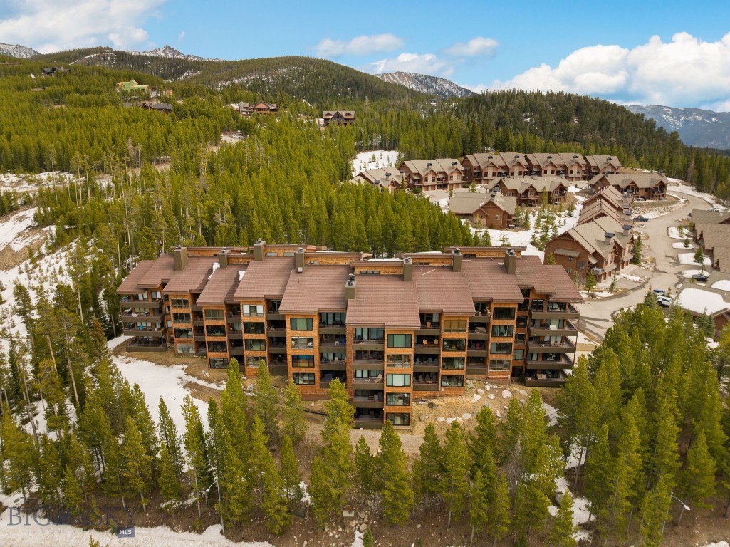 Located in Big Sky Resort’s Mountain Village, beneath the stunning and imposing view of Lone Mountain, 1702 Skycrest is a fully updated one-bedroom, one-bath mountain condo with unmatched peak views and resort access. A beautiful and thoughtful kitchen remodel plus extensive updates throughout have transformed this 821-square-foot retreat into a turnkey mountain property, offering you a move-in ready home away from home with modern finishes in one of Big Sky's best positioned buildings. This unit also carries a strong short-term rental history, making it an equally compelling investment opportunity in one of Montana's most active resort markets. Skycrest delivers the full package: underground heated parking, the convenience of an elevator, oversized gear storage with owner lock-off, a private patio with access to open space, and a Skyline Shuttle stop right outside the door. Inside, a wood-burning fireplace anchors the living space, large new windows create a mountain retreat setting, and all the comforts of home are stocked for you and your guests  — 1702 Skycrest, your perfect place to unwind after a day on the mountain.