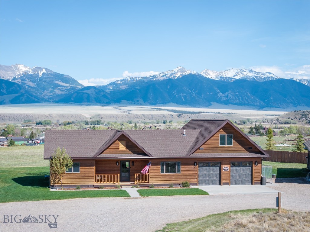 Set on an elevated 3.439-acre bench lot with panoramic views of the Madison River Valley and the Madison Mountain Range, this well-built property offers a hard-to-find combination of location, functionality, and flexibility. Those incredible views carry from inside the home all the way out to the redwood deck, yard, and firepit. A convenient walking path to downtown Ennis, local schools, and amenities is nearby.
This 2,913 SF home is well laid out for one-level living and entertaining. The primary suite on the main floor includes French doors to the deck, a walk-in closet, a clawfoot tub, and double sinks. The living room features solid walnut hardwood floors, vaulted wood ceilings, a gas fireplace, and mountain views. Two guest rooms share a ¾ bath, and a powder room is available for guests. The well-lit kitchen is equipped with alder cabinetry, a walk-in pantry, ample cabinet storage, bar seating, and a dedicated dining room.
A large bonus space above the garage includes a half bath and a small wet bar — well-suited for a home theater, craft room, or guest overflow.
The 900 SF guest apartment, added in 2023, is a standout addition. A fully self-contained one-bedroom unit with vaulted ceilings, a pellet stove, full kitchen, washer/dryer, and a ¾ bath — well-suited for guests, rental income, or multi-generational living.
The shop and both garages have epoxied floors. Properties with this much workspace and storage don't come up often. An oversized attached 2-car garage connects to the main home, a 900+ sq. ft. heated shop connects to the guest apartment, and a separate 30x48 mechanic's shop includes a 12-ft Atlas lift and a 30x12 side bay with three garage doors total.
Outside, a redwood deck and firepit are perfectly positioned to take in the mountain views. A circular driveway, sprinkler system, and well-maintained grounds keep things tidy and functional. A dry cabin with French doors adds useful extra space.
Additional details: fiber optic service, LED lighting throughout, Andersen windows, owned propane tank, well and septic. HOA fee is $200/year.