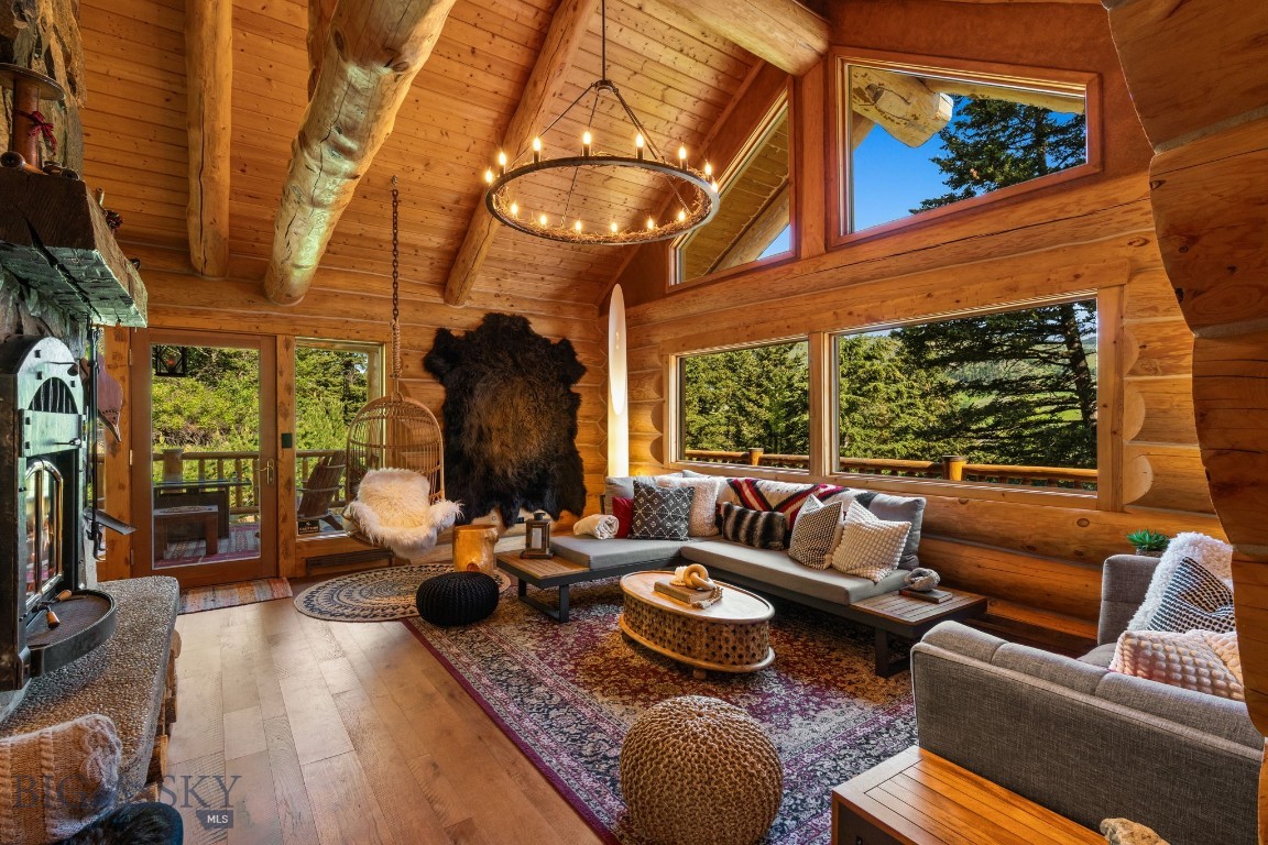 Welcome to the Cozy Alpine Chalet, a passionately handcrafted log home and legacy retreat, thoughtfully positioned on nearly 7 pristine private acres of alpine forest. Just 11 miles from both Bozeman and Livingston, and only 25 miles from Bozeman Yellowstone International Airport, the property offers effortless access to Montana’s finest dining, shopping, and outdoor adventure—yet feels like your own secluded mountain top forest escape, worlds away from it all. The main home has been extensively renovated between 2022 and 2025 with over $1 million in thoughtful upgrades including a full rebuild of mechanical systems, a smart home setup, professional interior styling, and high-end finishes throughout. Artisan log construction, natural wood and stone interiors, and over 30 Andersen windows bring in forest and mountain views from nearly every room, while six fireplaces create cozy gathering spaces indoors and out. This mountain retreat includes a chef’s kitchen with a full KitchenAid stainless steel suite, two laundry areas, and rich character in every detail. Tucked further into the trees, the Honeymoon Treehouse Villa is a newly built architectural jewel, elevated 15 feet above the forest floor. Built to Passive House / High-Performance standards, it features quadruple-pane glazing, premium insulation, and a future cantilevered hot tub deck, all framed by a soaring roofline designed for both elegance and energy efficiency. With all utilities installed and the interior ready for your finishing touch, this secondary structure offers limitless potential: a luxury rental, a serene guesthouse, or your personal creative retreat. This is a truly turn-key offering, with all furnishings, curated décor, bedding, chef’s cookware, and antiques included. Smart home features like Yale Wi-Fi locks, remote lighting and climate control, iPad/voice automation, and Starlink satellite internet ensure convenience and connectivity, even in this private setting. Whether you dream of taking over a luxury short term rental business (currently commanding up to $1300/night in the high season), creating a soulful family compound, or stewarding a rare legacy property for future generations…The Cozy Alpine Chalet awaits. With unmatched craftsmanship, immersive natural beauty, and an incredible location at the gateway to America’s first national park, this is truly Montana living at its finest.
