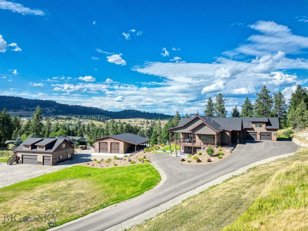 Every detail of this remarkable property tells a story of comfort, craftsmanship, and the Montana dream. Set on 5 private acres, boasting (3) separate dwelling spaces, each with designated parking. Enjoy sweeping mountain views of West Valley, it feels worlds away yet just minutes from Foy’s Lake, Lone Pine State Park, and downtown Kalispell. The main home features 4 BR's, 3 BA's on the upper floors. Thoughtful touches throughout include; gourmet kitchen w/ granite counters, butler’s pantry & custom lighting. The open floorplan and floor to ceiling windows in the living area allow copious amounts of natural light that transform the home’s features throughout the day. The lower level includes 2 add'l bedrooms, living area, kitchen, 3/4 bath + secret safe room. Expansive Trex decks, covered patios + hot tub beckon for enjoyment of versatile outdoor living. The smaller shop has in-floor heating and is a masterpiece in itself, equipped with two 50 AMP and one 30 AMP outlets, air hookups, oversized equipment port + half bath. The 2BR/2BA apartment above creates an elevated private haven for guests or caretakers. An additional shop boasts two 14-foot doors and comfortably accommodates a full-size motor home, boat, and much more. The substantial carport offers extra protection for recreational toys and equipment. These features are only a few that display the thoughtfulness in developing this property. In addition, with trails, lakes, and mountain adventure in every direction, this property is more than a home, it is a place that makes you believe you’ve found the last best place. Please see Documents Tab for a full list of property and home details!