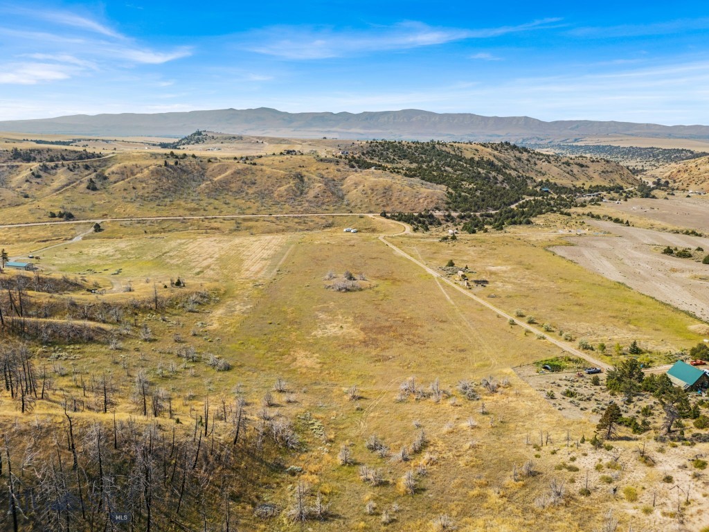 Nestled in rolling hills amidst a perennial blue-bunch wheat field awaits lot 180 with an established road right to the property. This almost 10 acre Montana property offers off-grid living with year-round access. Located in the scenic foothills of the Horseshoe Hills mountain range, it is just 15 minutes from public Missouri River access. Public land nearby makes it a great spot for fishing, rafting, and hunting.

The property is partially fenced and could be suitable for horses with a few updates. Enjoy mountain views, wide-open space, and a flat area ideal for building. Whether you are planning a full-time home or a weekend getaway, there is plenty of room for horses, gardens, and more.

For those who love stargazing, this location is a dream. With no light pollution, the night skies are incredible, and shooting stars are often visible. It’s a perfect setting for star gazers and astronomers, offering peace, quiet, and solitude away from the hustle and bustle of town.

The county maintains the road up to the nearby cattle guard on Pole Gulch, providing easier access. Located just outside of Three Forks, Montana, 50 minutes from the airport and about an hour from downtown Bozeman. This is your chance to own a piece of Montana.