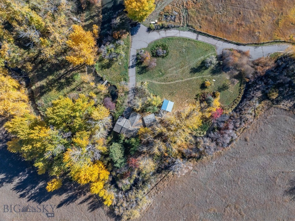 Located in the heart of Four Corners and just 15 minutes from downtown Bozeman, 3 Mallard Lane offers a rare blend of acreage, water features, and accessibility. Zoned Residential Rural, this over 33-acre property provides flexibility for a variety of residential and land-use possibilities. A creek winds through the property and feeds a peaceful pond, creating a serene setting complemented by expansive mountain views in every direction. Open pasture and mature trees define the landscape, offering privacy, usability, and a strong connection to the surrounding environment. The ranch-style dwelling features nearly 1,500 square feet of living space with 2 bedrooms and 1.5 bathrooms. Built in 1976 and remodeled in 1993, the home offers a functional layout with opportunity to personalize, expand, or use as a primary residence while planning future improvements. The home is served by a private well. Additional features include a greenhouse and shed, adding immediate utility for gardening, storage, or small-scale agricultural use. Paved road access ensures year-round ease while maintaining a quiet, rural feel. With its prime Four Corners location, Residential Rural zoning, and proximity to Bozeman, this property presents a unique opportunity to own substantial acreage with water, views, and convenience.