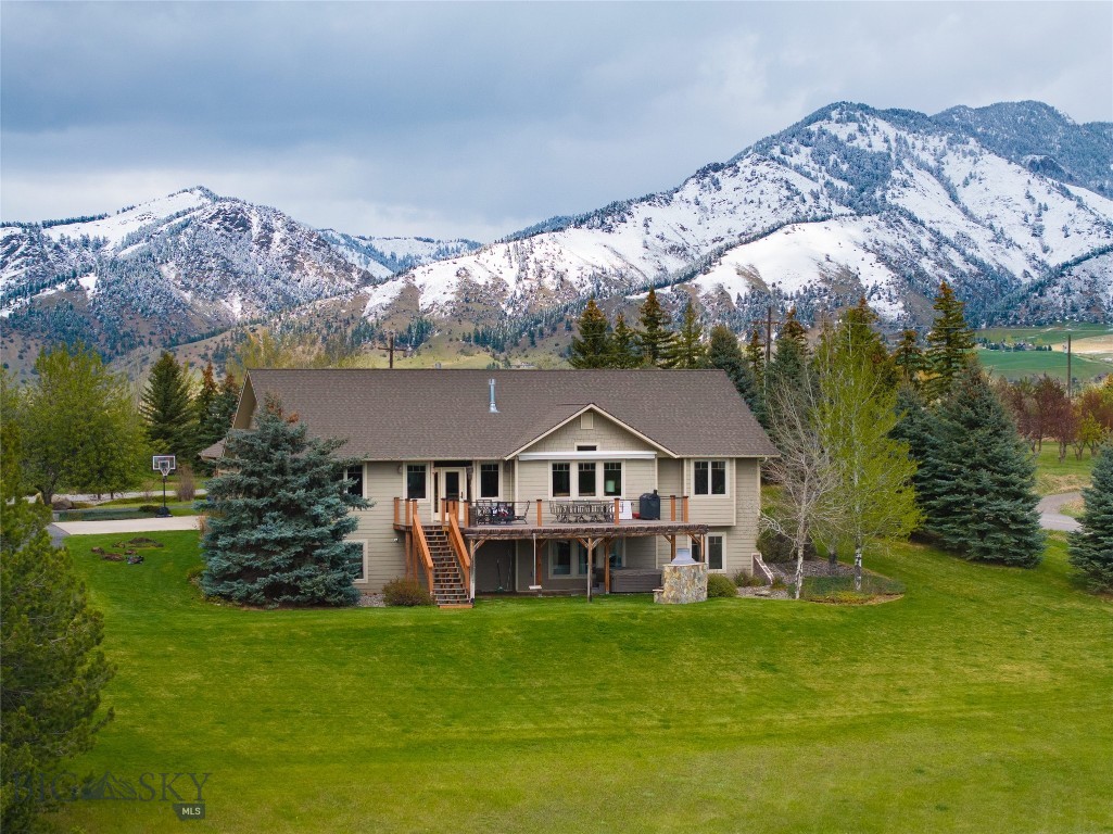 Set on over an acre in Summer Ridge, one of Bozeman’s most sought-after subdivisions, this beautifully designed 5-bedroom, 3-bathroom home offers over 4,400 square feet of Montana living. Thoughtfully planned with true main-level living, the home features a spacious primary suite and second bedroom on the main floor. The living room, dining room, and kitchen flow easily for entertaining, and a double-sided gas fireplace adds warmth and ambiance. The south-facing deck, complete with new Trex decking and a retractable awning, extends the living space outdoors—perfect for morning coffee, evening dinners, and taking in Montana’s stunning sunrises and sunsets. The fully finished walkout lower level is ideal for both everyday comfort and hosting guests. You will find a dining area, a huge living area, two lovely bedrooms, a bathroom, an exercise room, and tons of storage. The expansive backyard invites both relaxation and recreation, whether enjoying the hot tub or outdoor fireplace, watching sledding adventures in the winter, or creating your own garden. The three-car garage with epoxy flooring is perfect for large vehicles and all your Montana toys. Surrounded by nearby hiking trails and open space, yet just minutes from shopping, dining, and Bozeman Yellowstone International Airport, this property offers a rare balance of privacy and convenience. With generous space, thoughtful design, and an exceptional setting, this home is perfectly suited for those looking to live, gather, and fully experience the Montana lifestyle. Call your favorite agent today and schedule a private showing.