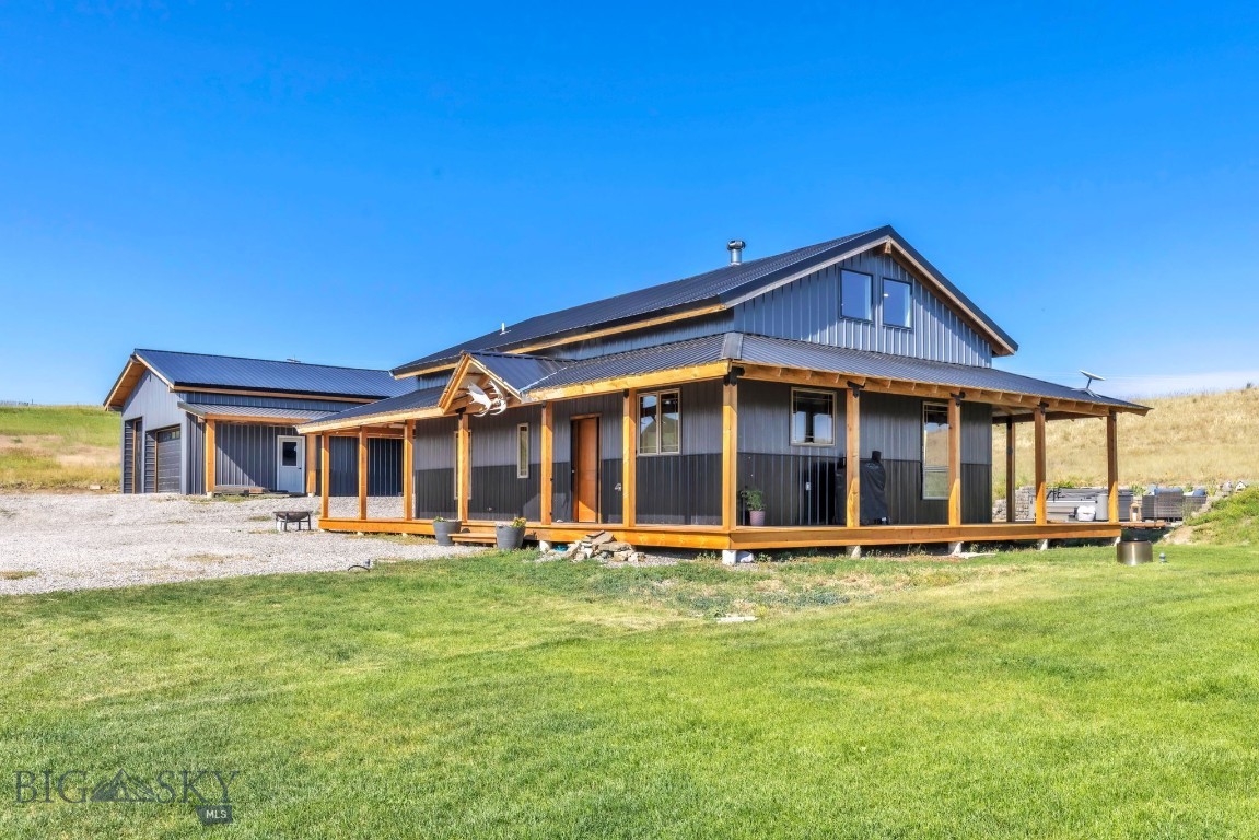 Built in 2023, this quaint craftsman home proves that good things come in efficient packages. Set on 10 rolling acres with views in nearly every direction, the thoughtfully designed floor plan lives large: 3 bedrooms, 2 bathrooms, cathedral ceilings, and a gorgeous great room anchored by a cozy wood-burning stove. A wrap-around deck extends your living space outdoors, perfect for soaking in the scenery — or simply working from home with a view that beats any office.
Upstairs, the primary suite is privately situated with its own attached bath and a peaceful reading loft, ideal for a remote workday or a quiet second-home escape. Step out back to the salt water hot tub for a soak under some of the clearest starry skies around.
The property is as functional as it is beautiful: a large shop/garage, pre-plumbed and generously designed, plus a greenhouse, chicken coop, garden, and partial perimeter fencing. All-underground electricity keeps sightlines clean, and paved W. Grannis Rd offers easy, reliable access year-round.
Low-maintenance, high-reward — a rare blend of craftsman charm, functional acreage, and Montana sky. Perfect property for a full-time, remote basecamp or a second home retreat, this one is special.