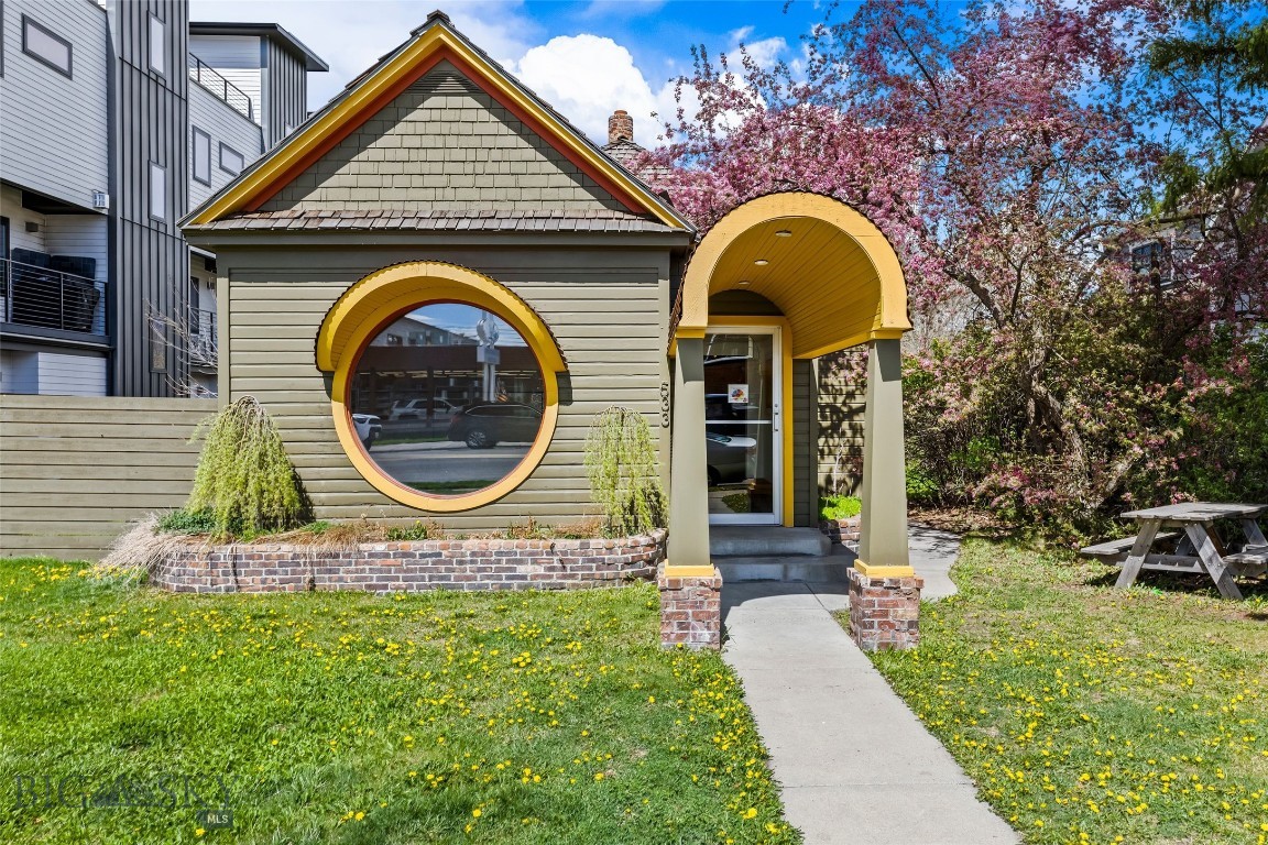 533 E Mendenhall presents a rare commercial opportunity just one block north of Main Street in downtown Bozeman. This distinctive historic building features eye-catching curb appeal with its iconic round window and arched entry, paired with a thoughtfully updated interior showcasing modern design, warm wood finishes, and flexible workspace. Ideal for office, retail, or studio use, the property offers excellent visibility, alley access with rear parking, additional street parking, and potential for future development or expansion.