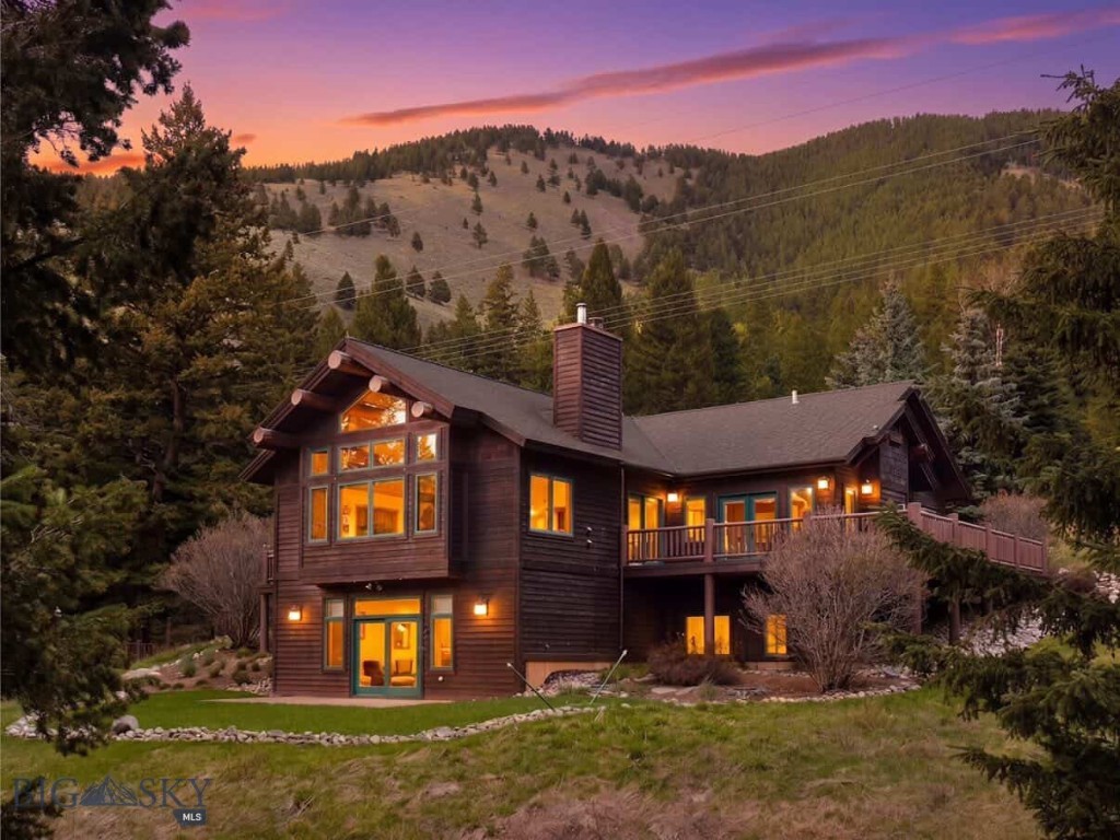 Experience the best of Montana living with this fully furnished mountain retreat located on 10 private acres in Gallatin Canyon. Just minutes from Big Sky and steps from the world-famous Gallatin River—a renowned blue ribbon trout fishery and world-class fly-fishing destination—this property offers unmatched access to outdoor recreation, fishing, hiking, and wildlife. It directly borders Gallatin National Forest, unlocking millions of acres of public land that stretch all the way to Yellowstone National Park. The custom-built home blends rustic charm with modern comforts. The main level features an open-concept living area with vaulted ceilings, fireplace, custom metal artwork, and floor-to-ceiling windows that capture expansive mountain views. A spacious, covered outdoor patio extends the living space and includes a wood-burning fireplace—perfect for year-round gatherings and enjoying the fresh mountain air. The primary suite is also located on the main floor, offering convenience and privacy. The walk-out lower level includes two additional bedrooms, a large recreation room with wet bar, and access to a stone patio and flat lawn—ideal for outdoor entertaining. Additional features include a heated detached garage with a workshop and an unfinished upper level offering potential for future expansion. The beautifully landscaped grounds include a horseshoe pit and a teepee, adding unique character to the outdoor space. Whether you're seeking a full-time residence or vacation getaway, this rare offering combines privacy, scenery, and proximity to Big Sky’s amenities. Zoned for flexibility and potential additional structures, it’s a true legacy property.