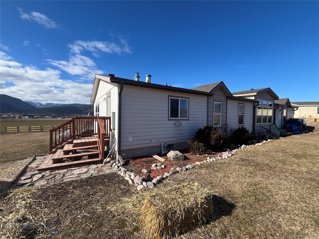 Come see this spacious 2,100 sq. ft. home situated on a full acre just west of Missoula, has beautiful mountain views. This property has very light covenants, is on well and septic, and has plenty of room to make it your own.

Recent updates include a new roof in 2025 and new front windows in 2024. Cozy up by the wood stove on cool Montana evenings or gather around the rock fire pit during the summer months. Outdoor enthusiasts will appreciate the close proximity to the Clark Fork River and King Ranch Golf Course.

If you've been looking for space, views, and an opportunity to create something special, this property deserves a look.
