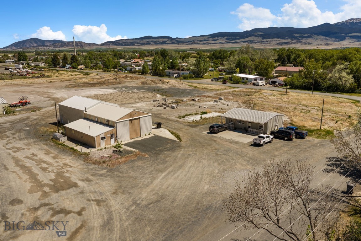Commercial investment opportunity featuring three buildings situated on approximately 4.57 acres of leased land within the Whitehall city limits.

The main building is an approximately 2,900 sq. ft. insulated warehouse/shop with office/reception area, half bath, and storage. Originally built in 1978, it was expanded in 2016 and includes a 12' overhead door. A second building offers approximately 552 sq. ft. of additional space.

The third building is a fully operational salon currently leased, providing immediate income to the new owner. The approximately 800 sq. ft. salon includes a full kitchen, half bath, two treatment rooms, laminate flooring, washer/dryer hookups, and a covered concrete patio.

Additional features include a large gravel parking area and convenient access within the city limits.

**Please note:** The buildings are located on leased ground through Montana Rail Link. Buyers should review the ground lease and terms for details.