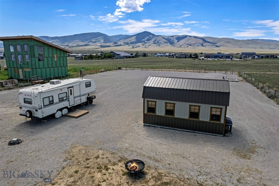 Bring The RV And Start Living The Montana Dream—The Hard Part Is Already Done. Pull in, plug up, and settle. This fully usable one-acre parcel on Berry Lane, just outside Townsend, is that rare "ready to build" opportunity where the infrastructure is already in the ground: power connected, septic installed, a brand-new high-producing well drilled, and approval in hand for two 2-bedroom living units. No covenants, no waiting—just room to breathe and a timeline that is entirely your own. The 2024 well is the standout, drilled to 501 feet with a strong 30 GPM flow. Good water is everything out here, and this parcel has it in abundance—plenty for a home, a garden, and the full Montana lifestyle. A 12x20 framed shed (built 2021) already makes the perfect camp headquarters: dining hall, bunk shed, or gear storage while you dream up what comes next. The whole acre is fenced, level, and open, framed by big Broadwater County sky and mountain views in every direction. Now picture the rest. Stand here as the sun slips behind the Big Belt Mountains and the light spills across Canyon Ferry Lake, and the life that could unfold comes into focus. Park the camper and enjoy your weekends now. Build the lake getaway you have been dreaming of. Or put down roots and raise your forever home right here—the choice is yours. Set in the heart of the Townsend Valley, you are just minutes from Canyon Ferry Lake and its world-class boating, fishing, and paddling, with the Big Belt and Elkhorn Mountains at your back and Helena, Bozeman, and Butte all within easy reach. Days out here fill themselves—hikes into the hills, evenings around the fire, stars coming out one by one. Well in. Septic in. Power on. Fenced and waiting. All that is left is your Montana story. Your Montana Home Is Waiting. Let's Go Find It.