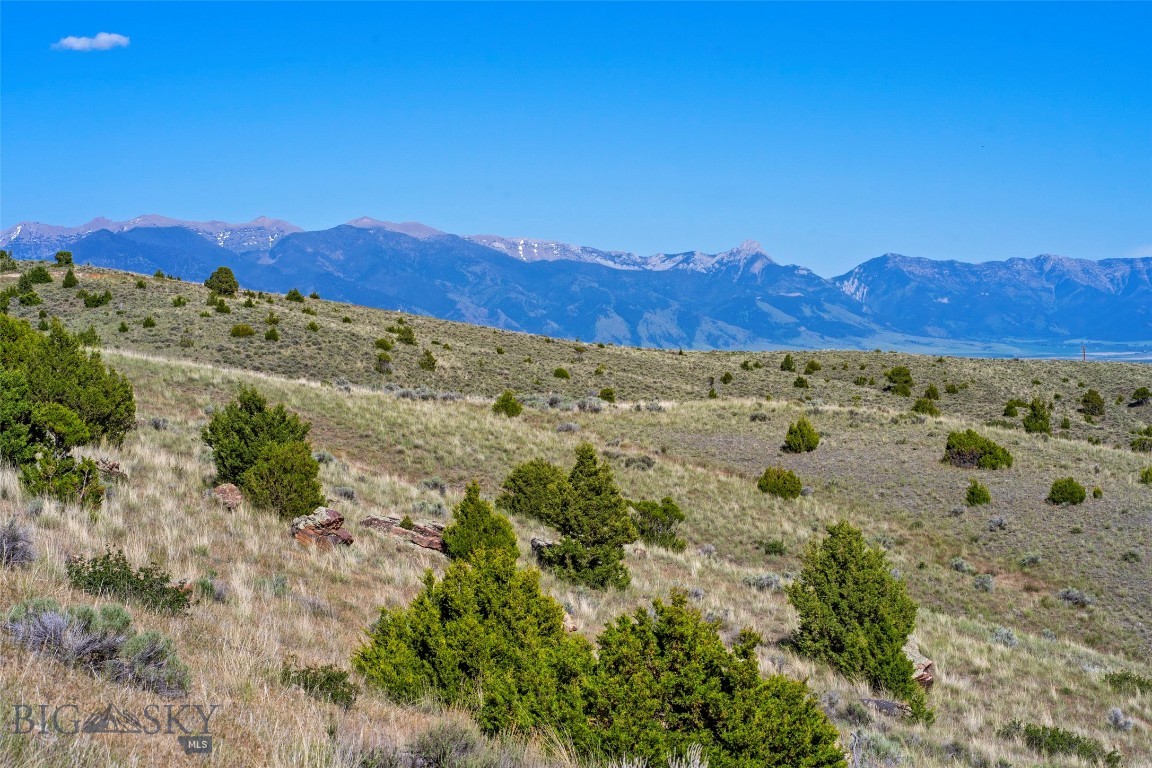 Discover 40 exceptional acres in Gallatin River Ranch, Manhattan MT —two adjoining 20-acre parcels offering sweeping valley vistas, layered mountain views, and the space to craft your Montana dream estate. Positioned along a striking natural rock band on the northern boundary, the land displays a beautiful mix of rugged character and open build sites, perfect for a primary residence plus additional structures like a barn, and guest quarters. Gallatin River Ranch is a one-of-a-kind community in the Gallatin Valley, known for its unmatched private Gallatin River access, state-of-the-art equestrian center, and miles of open space for horseback riding, hiking, and exploring the ranch’s stunning landscape. Just five minutes down the road, residents enjoy exclusive access to some of Montana’s most pristine blue-ribbon trout waters—a haven for anglers seeking solitude and world-class fishing. This area benefits from a warmer micro-climate, offering less snow and more moderate winter temperatures while still placing you within 1–2 hours of premier ski destinations. It’s a rare balance of year-round livability and Montana adventure. Though the setting feels a world away, convenience is close at hand - only 10 minutes to the charming and growing town of Manhattan, 20 minutes to Yellowstone International Airport, and 30 minutes to Bozeman. These parcels deliver privacy, views, recreation, and accessibility—an extraordinary opportunity to own a remarkable piece of the Gallatin Valley.