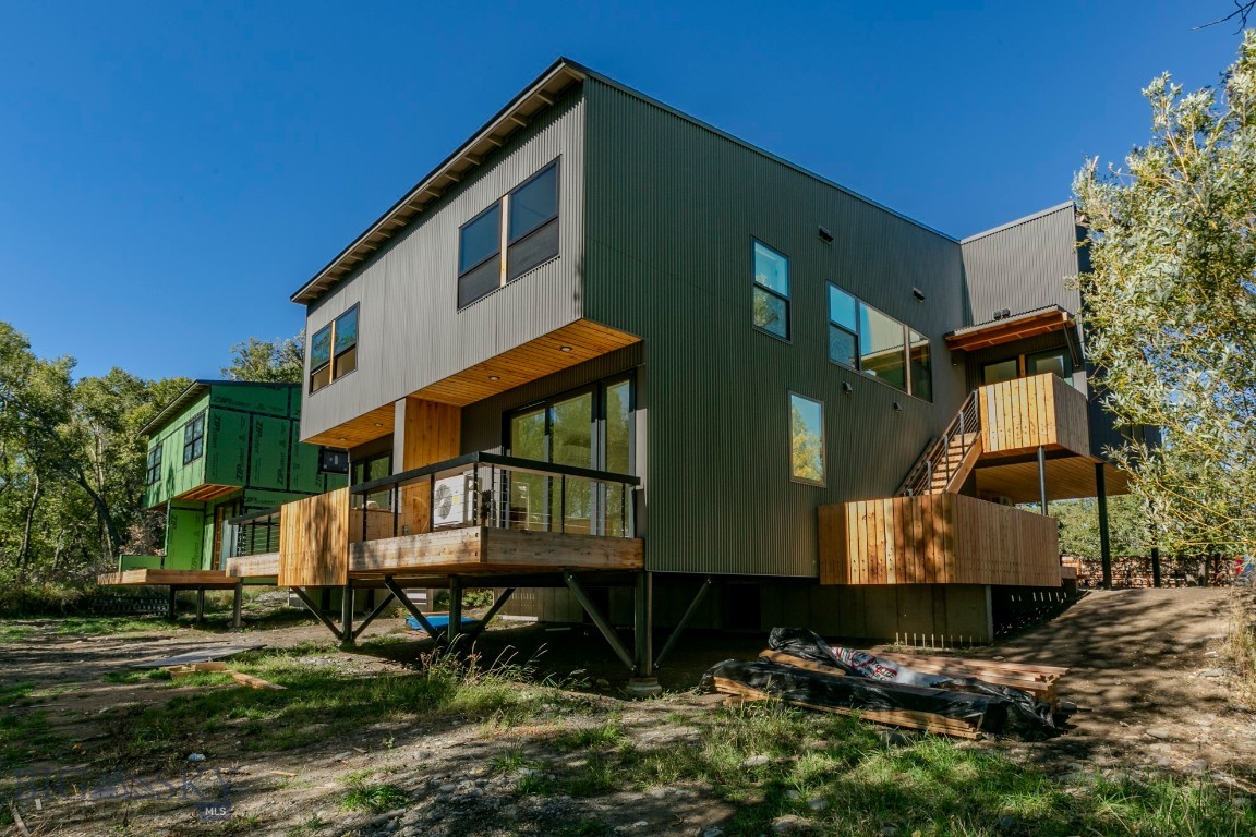 Fleshman Creek Condominiums offers  a newly built, architect designed 2 bedroom 2.5 baths condo with an attached ADU overlooking a quiet meadow on Fleshman Creek. The site offers a quiet private island in a typical Livingston neighborhood within easy walking distance to downtown shopping and restaurants. 

The main unit is a two level residence with living/dining and kitchen downstairs, including powder room, coat closet and a small wood burning Danish fireplace.  The living area opens to a spacious deck overlooking a peaceful meadow with the creek beyond. A one car garage and covered parking space are adjacent to the unit entry.  Upstairs is a primary suite with large windows overlooking the meadow and creek. It includes a walk-in closet, tiled shower room and separate vanity. Also upstairs is a full second bath, utility room with stacking washer dryer and a second bedroom. 

Included with the unit is a compact ADU ideal for guests, home office or supplemental income. Located over the garage, it is accessed by an outside stair to a good sized deck.  The unit includes a full kitchen, living dining room with a wood burning fireplace, separate bedroom and walk-in closet with stacking washer dryer. The unit enjoys views of the meadow and creek from the deck and the living area. 

Designed by architect Thomas Blurock FAIA,  know for award winning residential and education projects the unit offers design touches such as large expansive window, natural wood cabinets and interior doors, stainless steel appiances, steel cable railings and wood burning Danish fireplaces.

Fleieshman Creek Condos offer quality, low maintenance units ideal for a residendence, vacation getaway or investment.