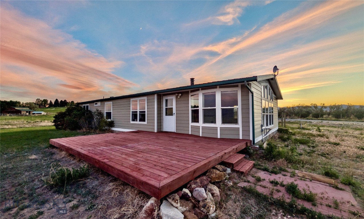 Enjoy the best of both worlds: the convenience of proximity to town with horse and livestock amenities. This well-maintained 3 bedroom, 2 bathroom, 1590+/-sf manufactured home, is situated on 5.01+/- irrigated acres. The location offers privacy with a remote feel, plus exceptional views of the Beaverhead Valley’s surrounding mountains. This property is ideal for horse enthusiasts, hobby farmers, families with 4-H projects, or anyone seeking room to roam. The home has been charmingly updated, and has new exterior siding, all new interior doors, a newer furnace, and a durable metal roof, major ticket items already in place. Outside, the property is set up for horses with wood rail corrals and ample space for riding and grazing. A spacious 40’x 60' shop with a tack room and utility room offers excellent storage, workspace, and versatility for equipment, livestock needs, or recreational projects. Whether you're enjoying the stunning Montana scenery, caring for animals, or simply appreciating the privacy and open space, this property delivers the rural lifestyle you've been looking for—without sacrificing convenient access to town.