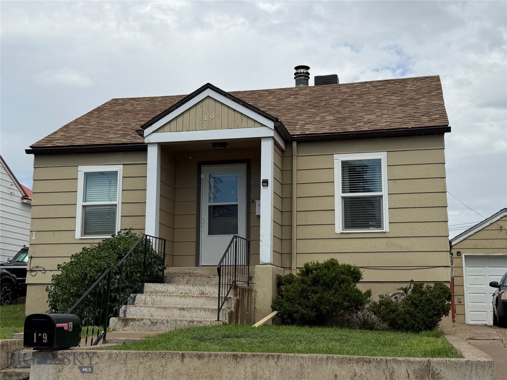 Welcome home to affordable living in rural Shelby, MT. You will appreciate that the style and charm has been retained with a real brick fireplace, original hardwood floors and open, painted cabinets while also adding new elements like tile a tile shower and modern vanities. Plus, sellers have replaced windows, added handsome white blinds and a newer deck off the kitchen. The fenced backyard has mountain views and a detached garage. There are two bedrooms and a full bath on the main level, along with living and dining space and a galley kitchen with stainless steel appliances. The lower level offers a non-conforming bedroom, recreation room, a 3/4 bathroom and a laundry space with washer and dryer being included in the sale. The exterior front of the home has a covered porch. Access is ideal with close proximity to city services and across the street from a small park. There are several hunting and fishing spots nearby, too.