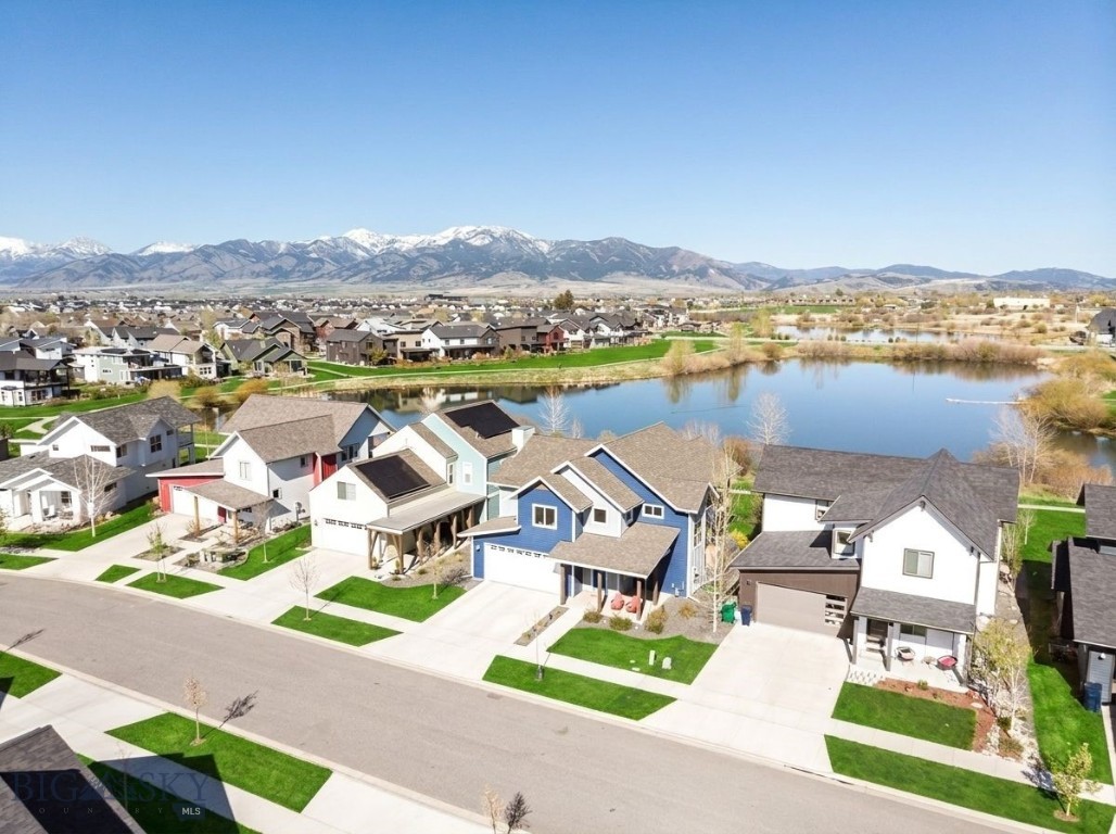 Arguably one of the premier homesites in The Lakes at Valley West, this exceptional west-shore property offers breathtaking views of the Bridger Mountain Range and direct access to small lake living right out your back door. Enjoy fishing, paddleboarding, and serene waterfront sunrises from one of the community’s most coveted locations.

Filled with natural light, the home showcases modern finishes throughout, including quartz countertops, warm floors, new carpet, stylish lighting, and Belmont cabinet package. The thoughtfully designed floor plan features the kitchen, living room, mudroom, guest bedroom, and guest bath on the main level.

Upstairs, the spacious primary suite captures stunning lake and mountain views and is complemented by a secondary family room, laundry room, two additional guest bedrooms, and a guest bathroom. A covered balcony off the upper level family room provides the perfect place to relax while overlooking the water and surrounding mountain ranges.

Outdoor living is abundant with a covered front porch, covered patio, and expansive covered balcony, creating multiple spaces to enjoy the scenery year-round. Additional comforts include air conditioning, a gas fireplace, whole-house humidifier, and a private outdoor barrel sauna, making this home a true retreat. In addition to its two scenic lakes, the neighborhood amenities also offers an impressive playground and interconnected trail system to other parks, schools, and neighborhoods.

The sweeping views from the living room, family room, and primary suite are truly unforgettable. Don’t miss this hidden gem in The Lakes at Valley West.