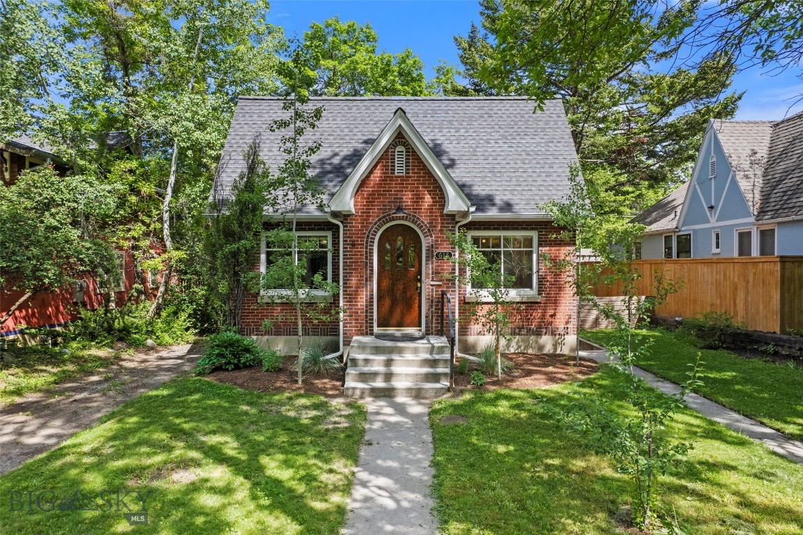 Welcome to 618 S 7th Avenue, a timeless brick residence nestled in Central Bozeman's Cooper Park neighborhood. Built in 1930, this charming home beautifully blends historic character with thoughtful modern updates, offering an exceptional opportunity to enjoy the best of downtown Bozeman living. The main level features two bedrooms and one remodeled bathroom, complemented by an airy and inviting living and dining area filled with natural light. Original architectural details, such as the hardwood floors, showcase the home's enduring craftsmanship, while the recent rewiring of the house and garage and the renovated kitchen, bathrooms, and basement provide modern functionality and style. Downstairs, a complete renovation has transformed the lower level into a versatile extension of the home. Featuring two additional bedrooms, a 3/4 bathroom, laundry area, and two flexible living spaces, the lower level offers endless possibilities for a home office, media room, or guest quarters. With its own private exterior entrance, the lower level presents an ideal setup for separate living quarters. Outside, the fenced backyard serves as a private urban retreat. An expansive deck overlooks mature landscaping and old-growth trees, creating a peaceful setting for entertaining, relaxing, or enjoying Montana's evenings. A detached single-car garage equipped with 220V power provides additional storage and utility. Located just a 15-minute walk from both Montana State University and Bozeman's vibrant Main Street district, this property places restaurants, shopping, parks, trails, and community events right at your doorstep. Rarely does a home combine this level of character, flexibility, and location in the heart of downtown Bozeman. Come experience the downtown Bozeman lifestyle you've been dreaming of.