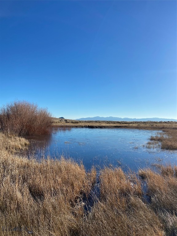 Big Sky county at its finest- the expanse of Montana welcomes you from every spot on this lovely 20+/- acre parcel. Views of surrounding mountains in all directions and easy access to the spectacular Pioneer Mountain Range and the recreational opportunities that are endless: camping, hiking, fishing, mountain lakes, cross country skiing, snowmobiling, sidexside exploring, hunting or just drinking in the views, this location and parcel are exceptional. Improvements on this parcel are extensive and include; custom fence, well (!), power to the 100x100 building pad plus 400’x22’ driveway with 6” of select road grindings added on top. This parcel truly is ready for you to settle in and build your vacation home, permanent home or just visit when you need to get to paradise. Property borders State ground which in turn borders BLM and USFS.