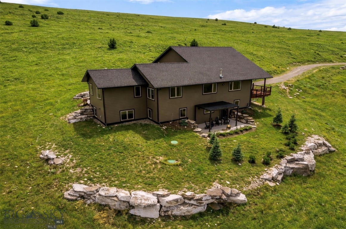 Wide Open Spaces & Mountain Modern Comfort
Experience the perfect blend of privacy, luxury, and Montana’s great outdoors in this 4-bedroom, 3-bathroom mountain modern home. Spanning 3,456 sq. ft. with a 3-car attached garage, this property sits on 19.28 acres at the end of the road, offering unmatched seclusion and tranquility. Numerous outdoor living areas invite relaxation, from the hot tub and sauna to serene seating spots perfect for watching the sunrise and sunset, gathering around the firepit, or stargazing under Montana’s vast night sky. Raised garden beds provide the perfect touch for green thumbs.

Inside, recent updates enhance the clean, modern design while maximizing comfort and function. Private neighborhood access to the Gallatin River offers world-class fishing and floating. Numerous trails for hiking, biking, and horseback riding, along with nearby state land, make this an outdoor lover’s dream. In winter, major ski hills are just a short drive away. Conveniently located outside the charming town of Manhattan and the vibrant restaurants, events, and amenities of Bozeman, with the international airport nearby for easy travel, this property offers the rare combination of wide-open spaces, refined living, and direct access to Montana adventure.